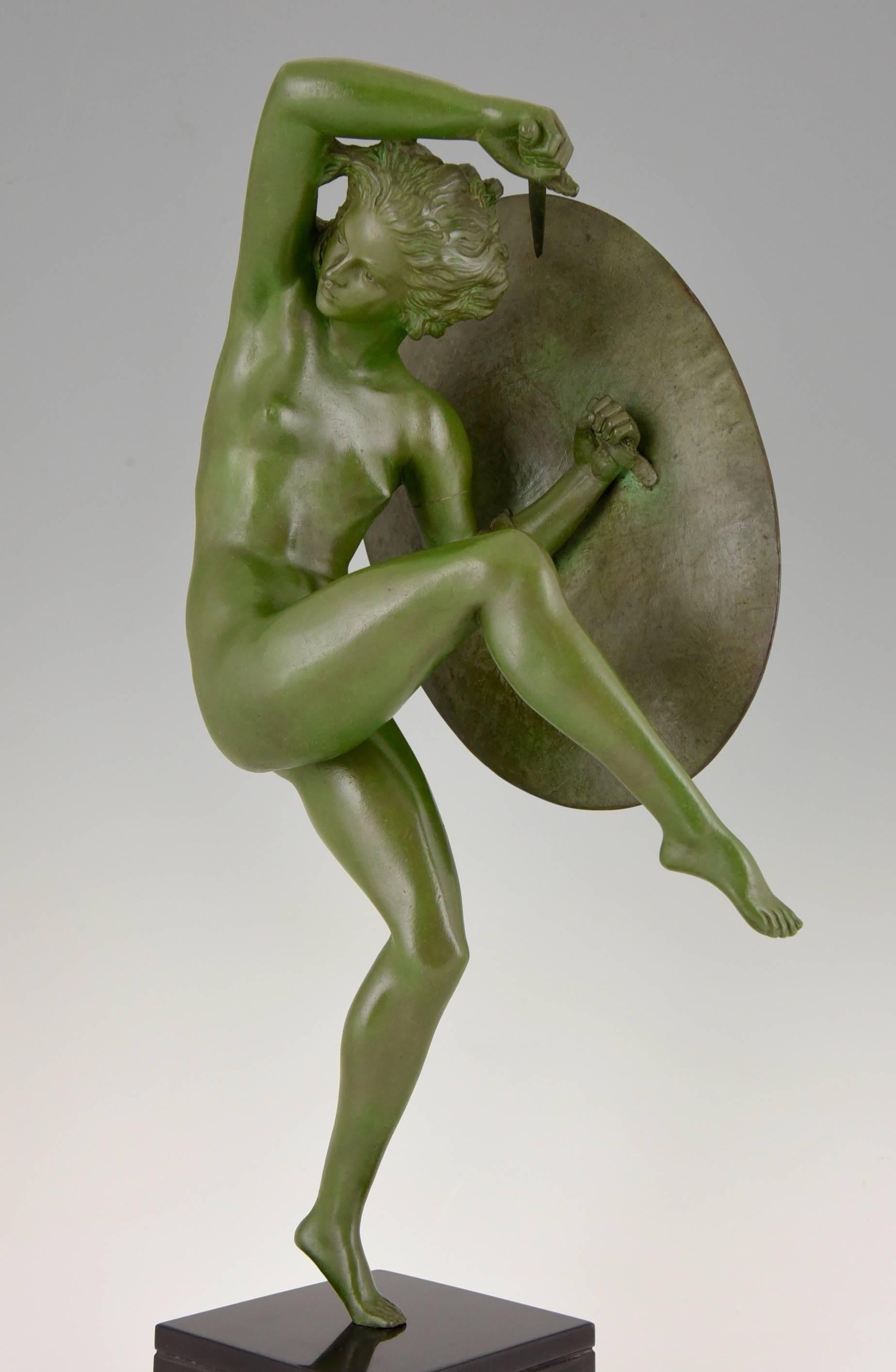 Title:  Athena.
Description: Dancing nude holding a sword and a shield with a central mask. 
Artist/Maker: Marcel André Bouraine, 1886-1948. 
Signature/Marks: Bouraine , Stamped “bronze”.
Style:  Art Deco. 
Date:  circa 1930
Material: