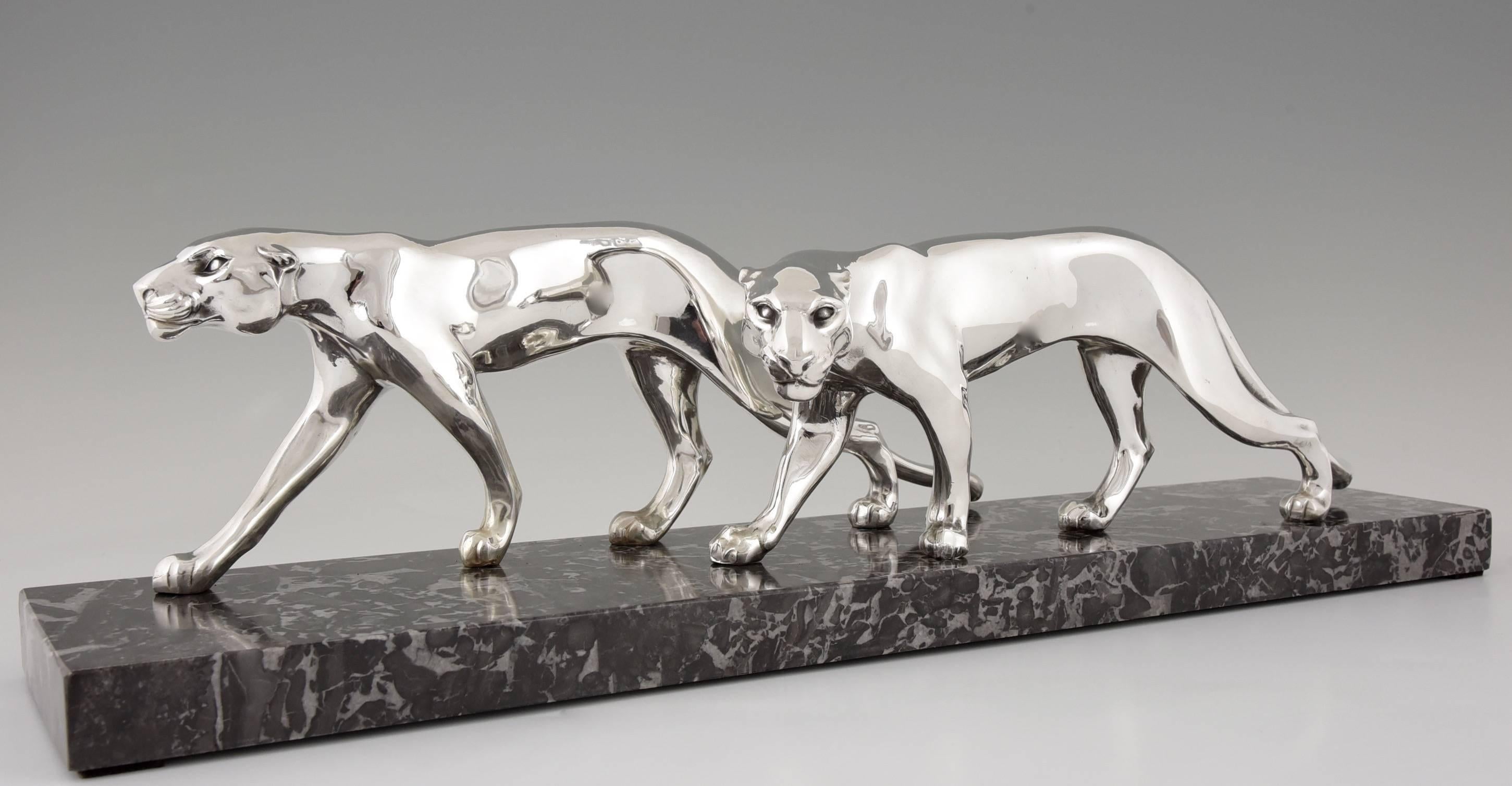 Description:  Art Deco silvered sculpture of two panthers
Artist / Maker:  M. Font. France.
Signature:  M. Font on the marble base.
Style:  Art Deco.		
Date:  1930.			
Material: Silver plated metal.  Marble base.	
Origin:  France.