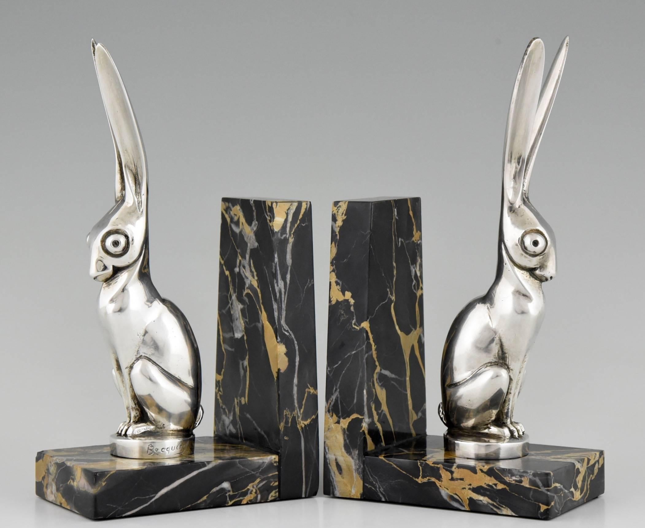 Description:  A pair of Art deco silvered bronze hare bookends. 
Artist/ Maker:  André Vincent Becquerel,
Signature/ Marks:  Becquerel. Etling Paris foundry mark. 
Style:  Art Deco.	
Date:  Ca.1930.
Material:  Silvered bronze on a Portor