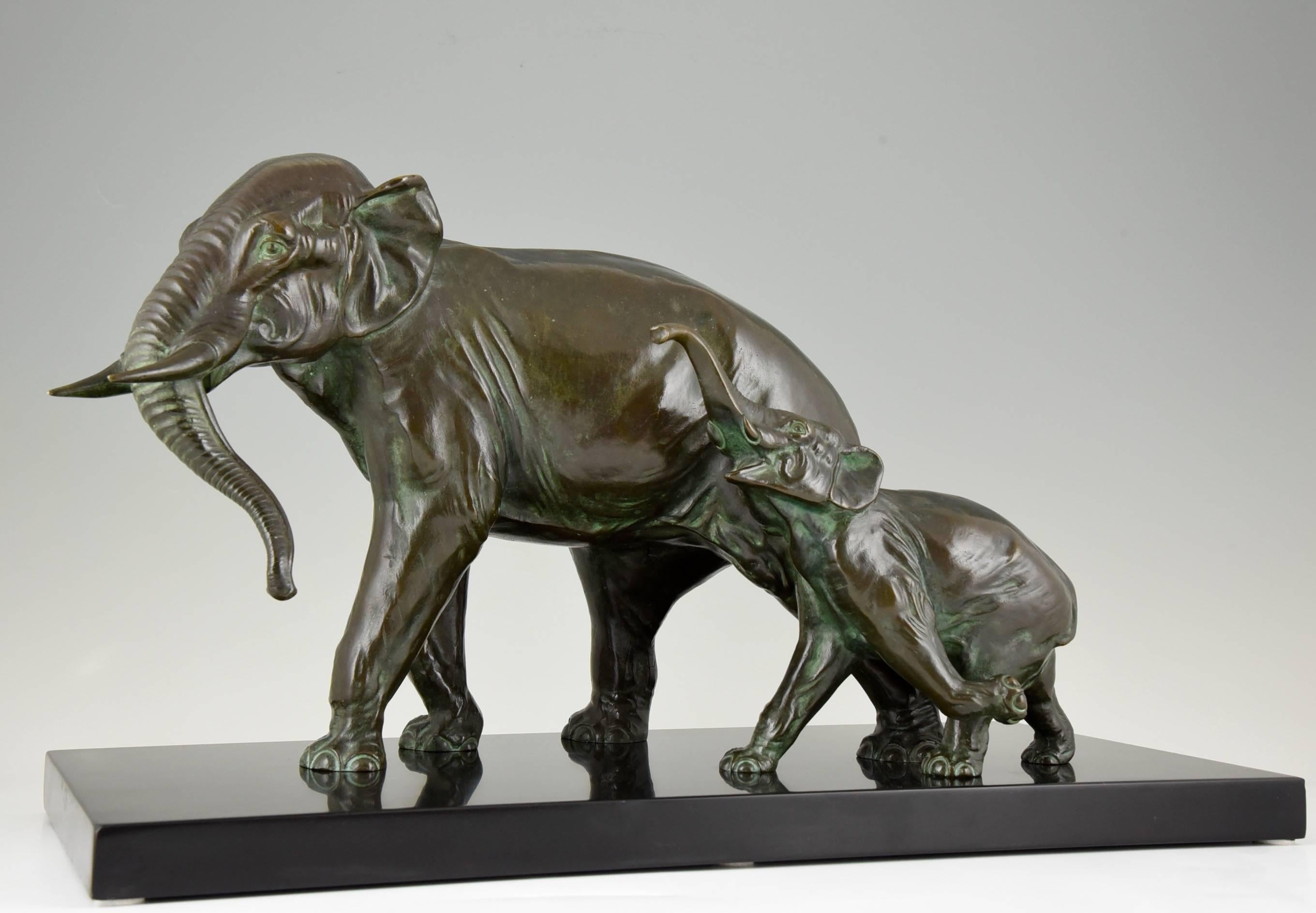 Description:  Impressive bronze Art Deco group of mother and baby elephant on black marble base.
Artist/ Maker: Irénée Rochard.
Signature/Marks: Rochard on the mother elephant.  Bronze.
Style: Art Deco.
Date: 1930.
Material: Bronze with dark