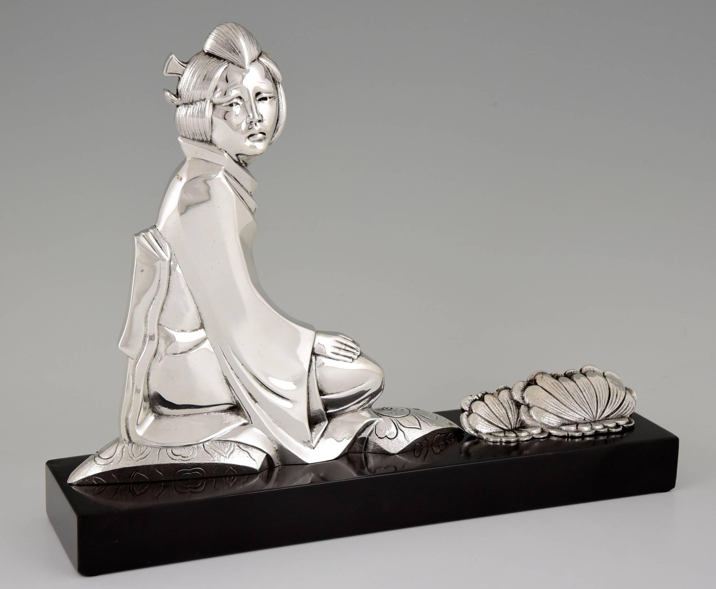 Description: A French Art Deco silvered bronze of a oriental lady with lotus flowers. 
Artist/maker: P. Berjean. 
Signature/marks  P. Berjean. 
Style: Art Deco.
Date: circa 1930.
Material: Silvered bronze on a marble base. 
Origin: