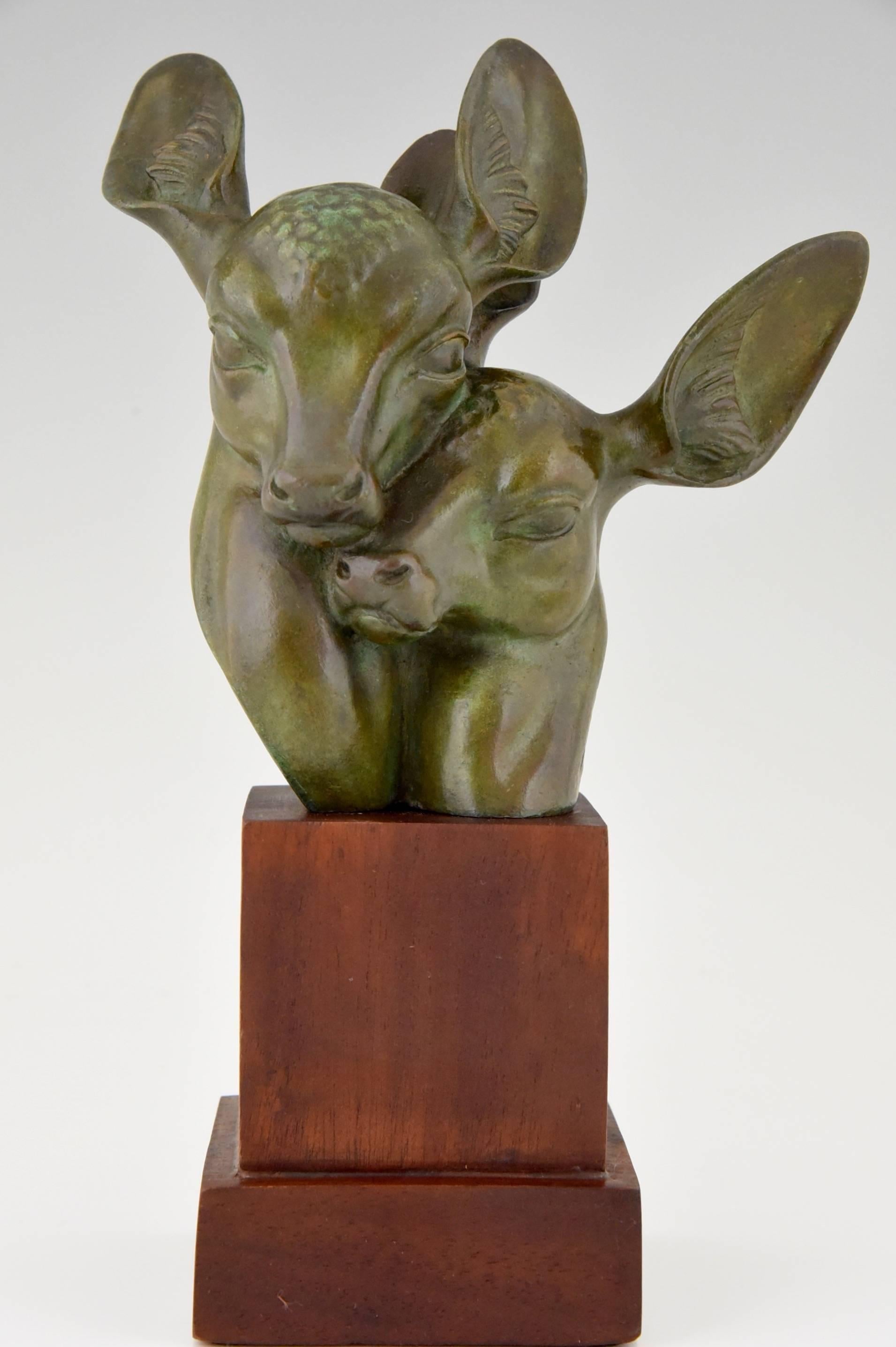 Description: Art Deco bronze bust of two deer. 
Artist/ Maker: Georges H. Laurent.
Signature / Marks:  G.H. Laurent. Bronze.
Style: Art Deco. 
Date: 1925/1930.
Material: Patinated bronze. Wooden base.
Origin: France. 
Size: 
H 11 inch x L