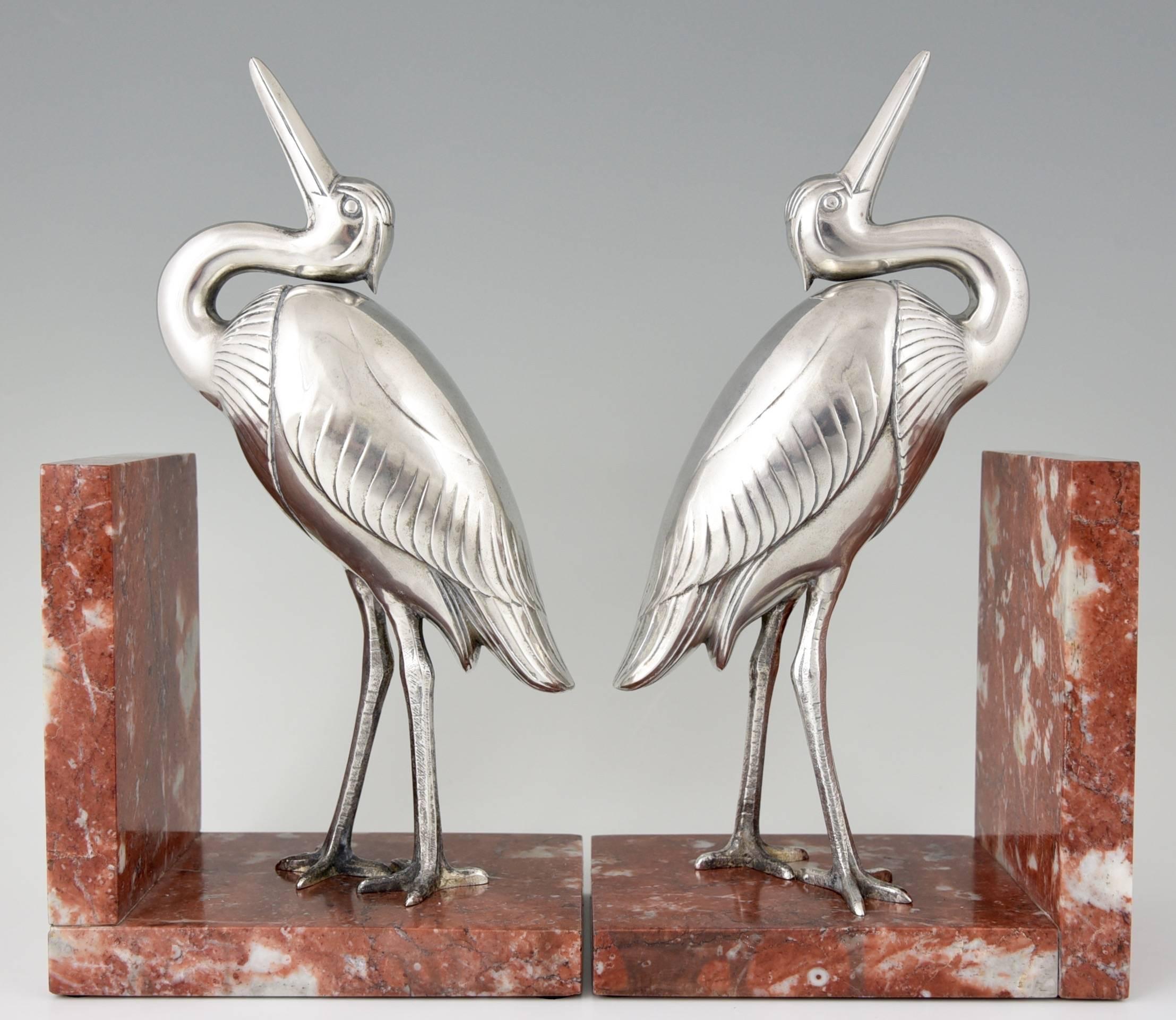 Description:  Art Deco silvered metal heron bird bookends. 
Artist / Maker:  Irénée Rochard. 
Signature / Marks: Rochard.
Style: Art Deco. 
Date: 1930.
Material: Silvered metal. Marble base. 
Origin:  France. 
Size of one:
 H 12 inch. x L