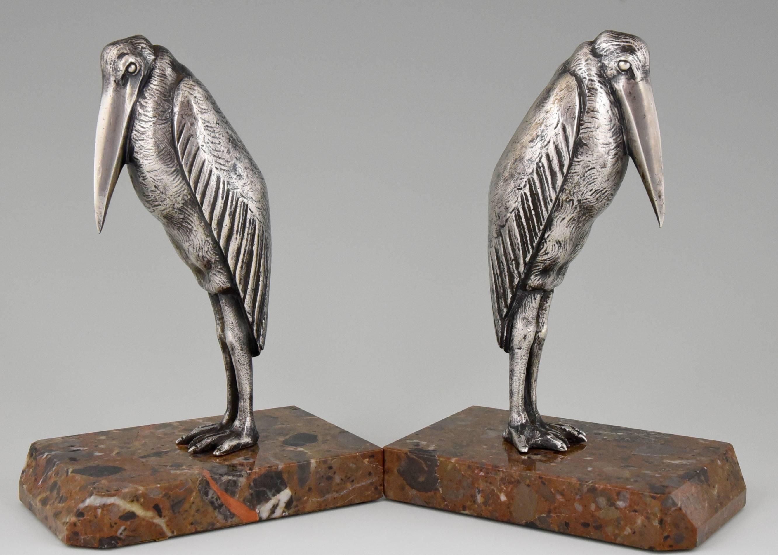 Description: 
Marabou bookends by Claude & Marcel Guillemard. 
Signature/ Marks: 
Claude, Marcel Guillemard foundry, numbered.
Style:
Art Deco.
Date:
circa 1925.
Material: 
Silvered bronze on marble