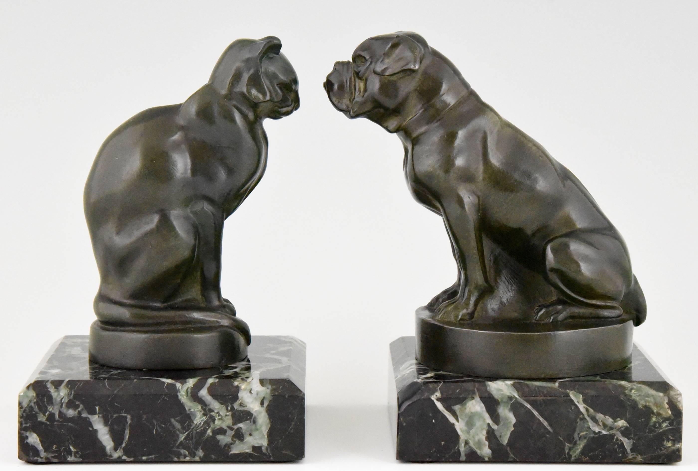 Description:
A pair of Art Deco figural bookends in the shape of a cat and bulldog. 

Artist / Maker:.
Max Le Verrier. 

Signature / Marks: 
M. Le Verrier.

Style:
Art Deco.

Date:
1930.

Material: 
Green patinated metal.
Marble