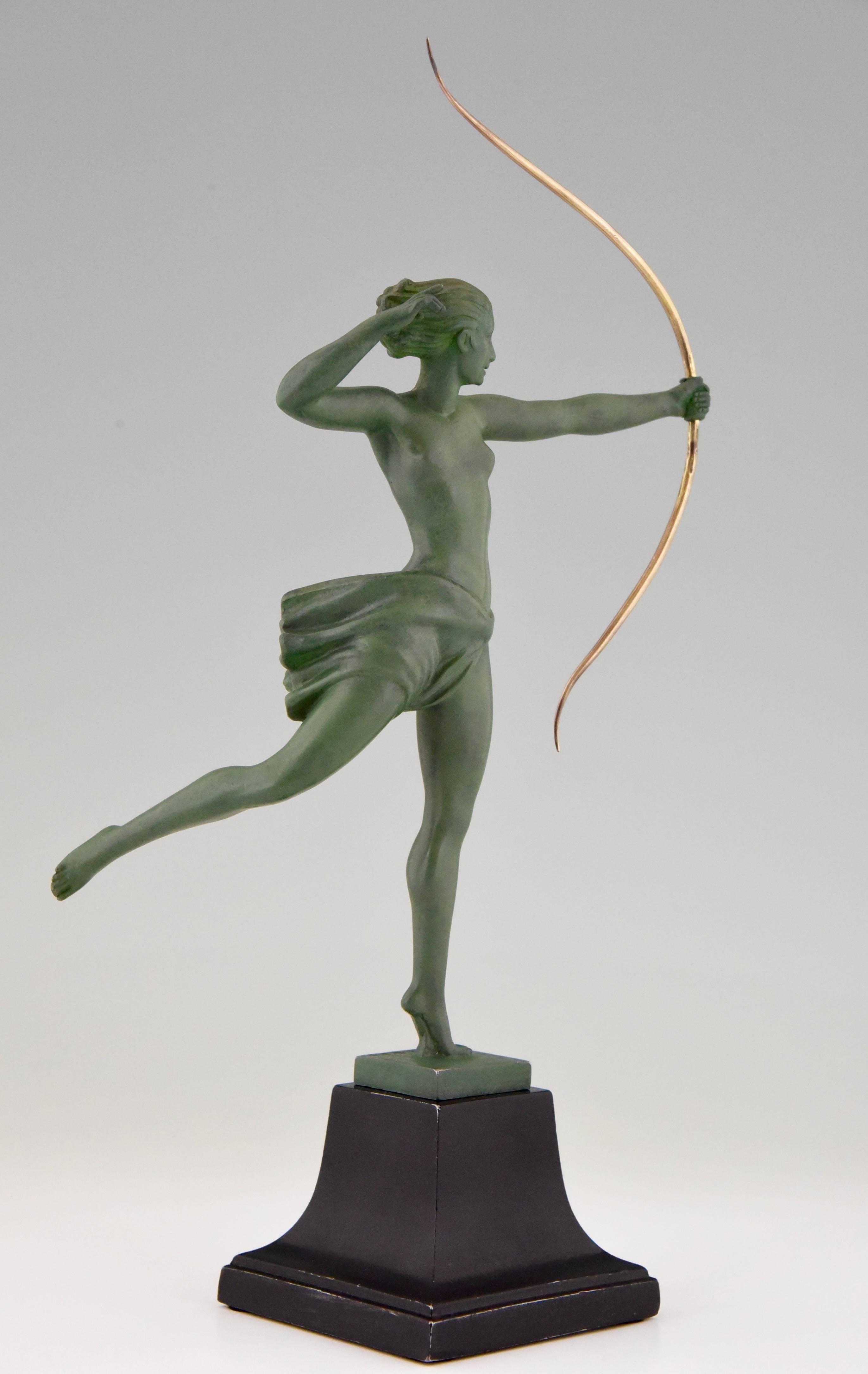 Diana, Art Deco nude with bow. 
Artist/ Maker: Jean de Marco.
Signature/ Marks:  Demarc.  Cast by the Max Le Verrier foundry. 
Style:  Art Deco.
Condition:  Good original condition, see pictures. 
Date: circa 1935.
Material: Metal with green