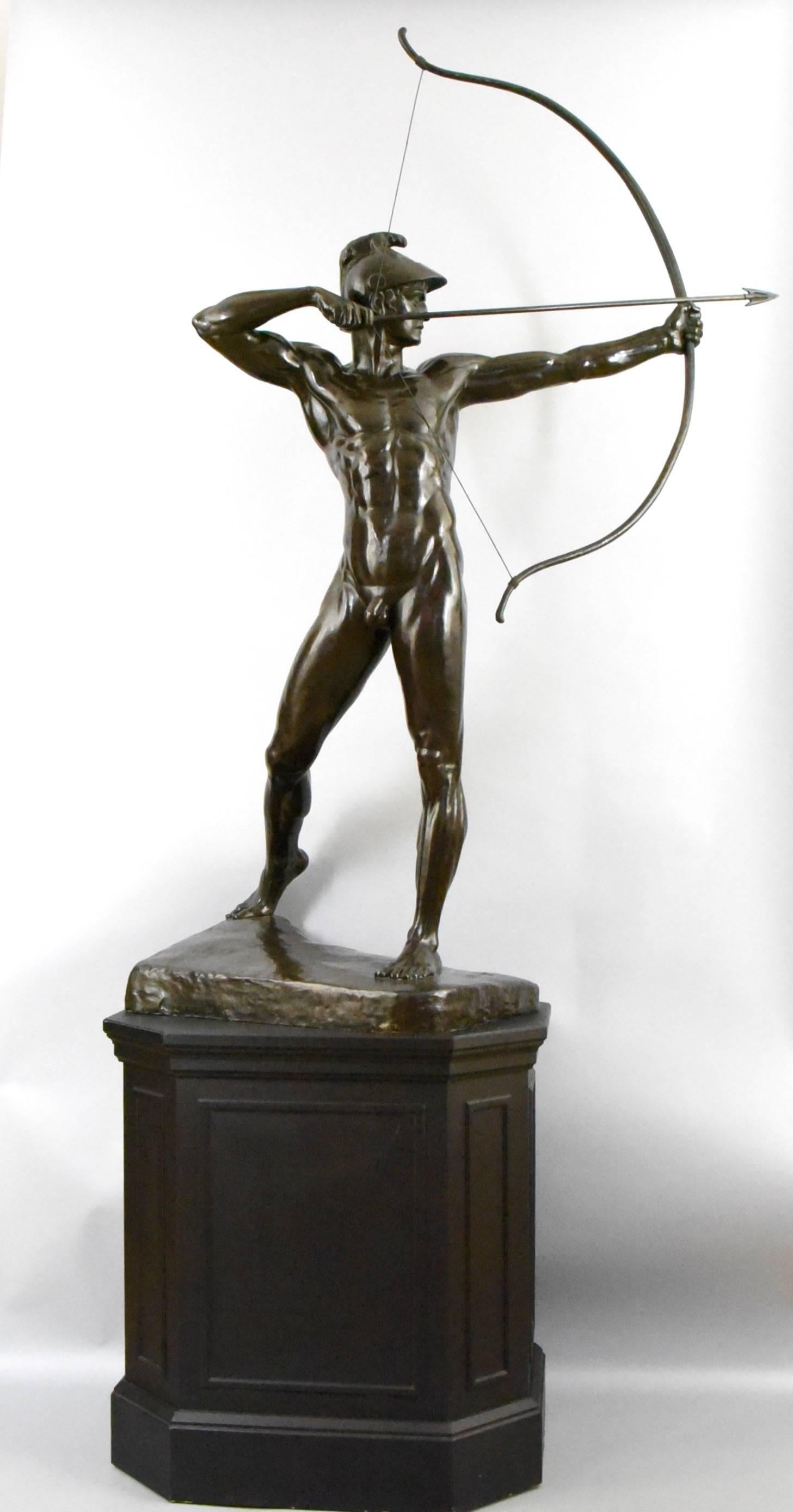 The Archer. 
Bronze sculpture of a male nude with bow and helmet. 
Wooden base. 
Height including the base: H 80.3 inch. or H 204 cm. 
Artist/ Maker: Ernst Moritz Geyger 
Signature / Marks:  E. M. Geyger fec. 
Date 1900. 
Material: Patinated