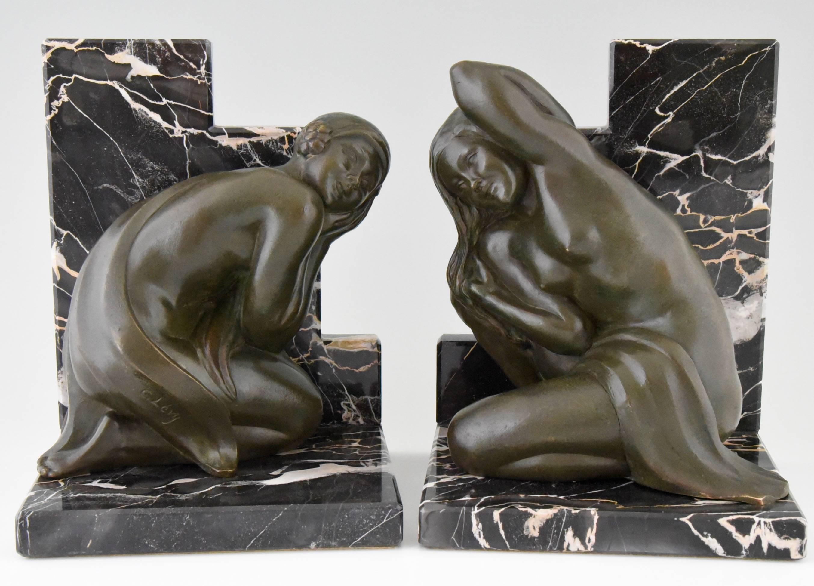 
Description:  Art deco bronze bookends with kneeling nudes. 
Artist/ Maker: Clarisse Levy Kinsbourg (Born in France in1896).
Signature/ Marks: C. Levy.
Style: Art Deco. 
Date: circa 1930. 
Material: Patinated bronze.  Marble base. 
Origin:
