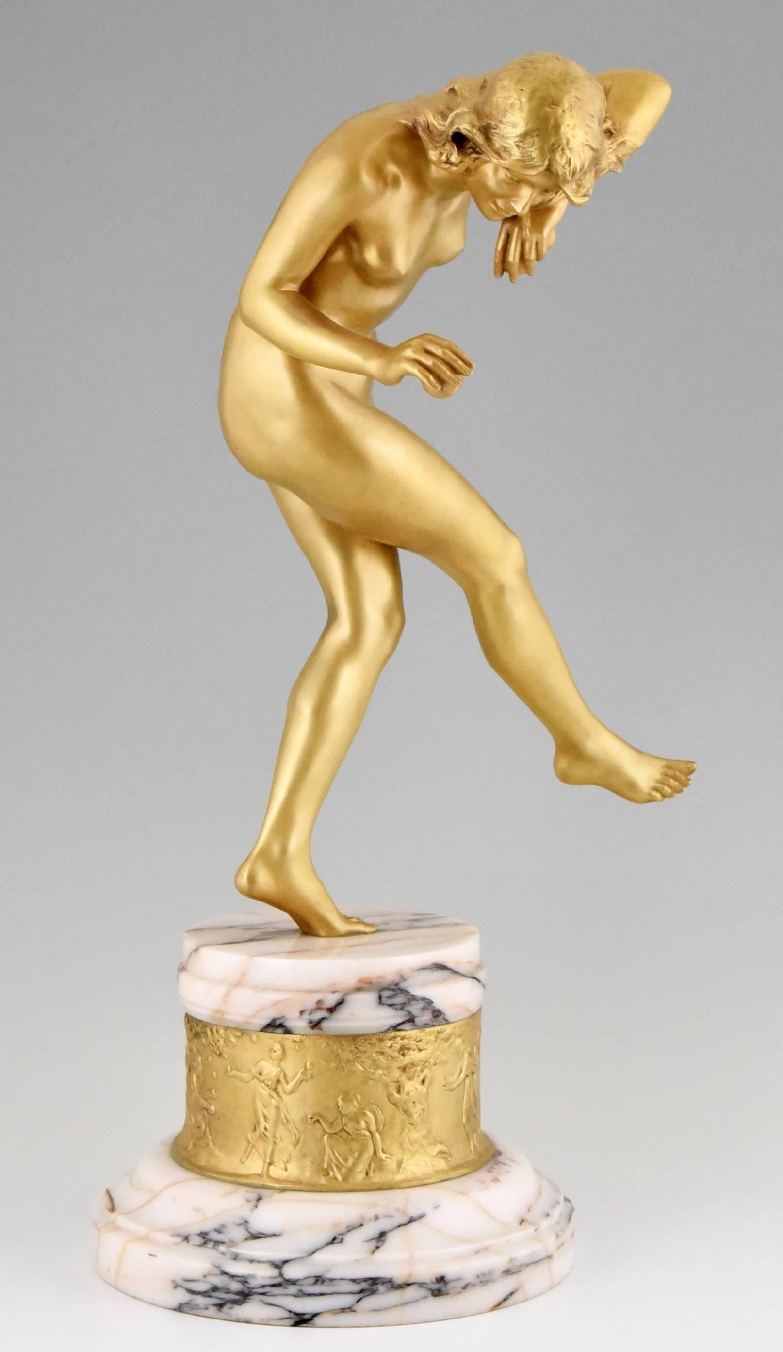 An Art Nouveau gilt bronze nude on a marble and bronze base by Louis Marie Jules Delapchier, 
The base has a gilt bronze relief decoration of nymphs dancing between trees. 
Titel:  “Dance of the apple” 

Artist/ Maker:  Delapchier, Louis Marie