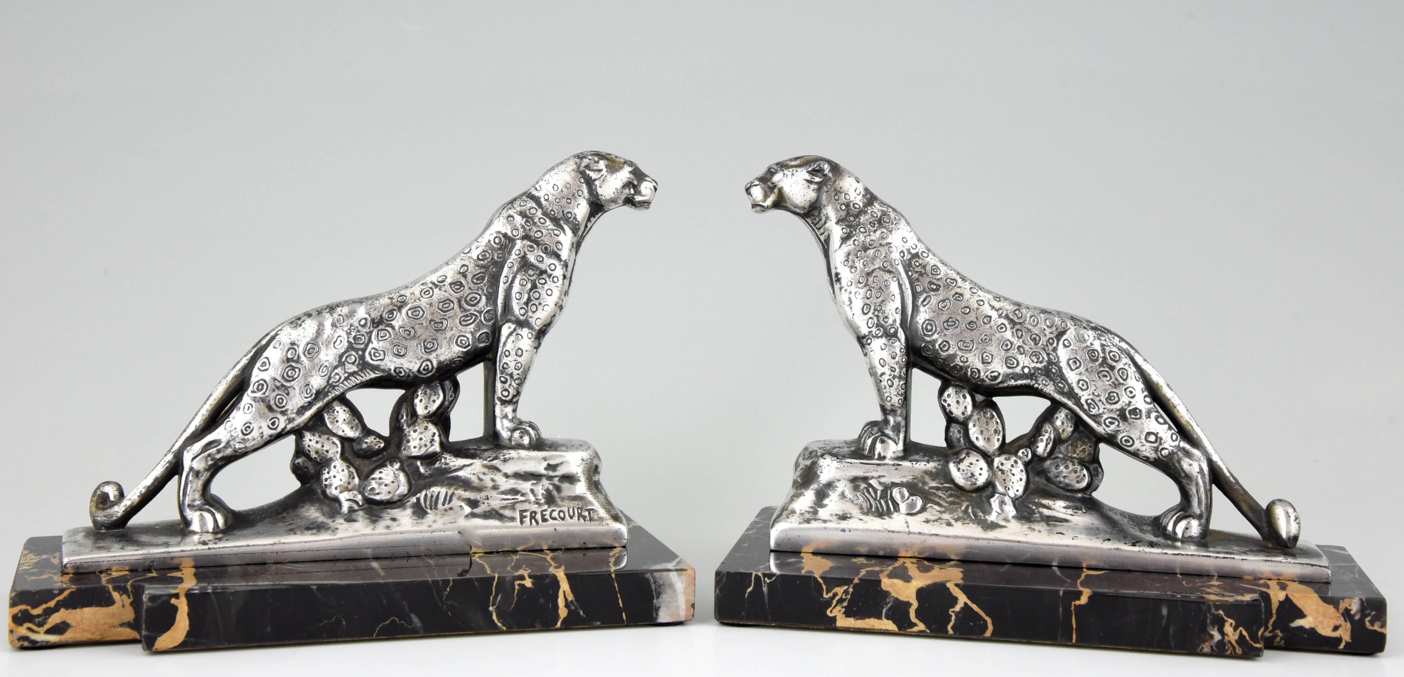 An elegant pair of Art Deco leopard panther bookends by the French artist Frecourt on a portor marble base. 

Artist/ Maker: Maurice Frecourt.
Signature/ Marks: Frecourt.
Style: Art Deco.
Date: 1930.
Material: Metal with silver patina. On