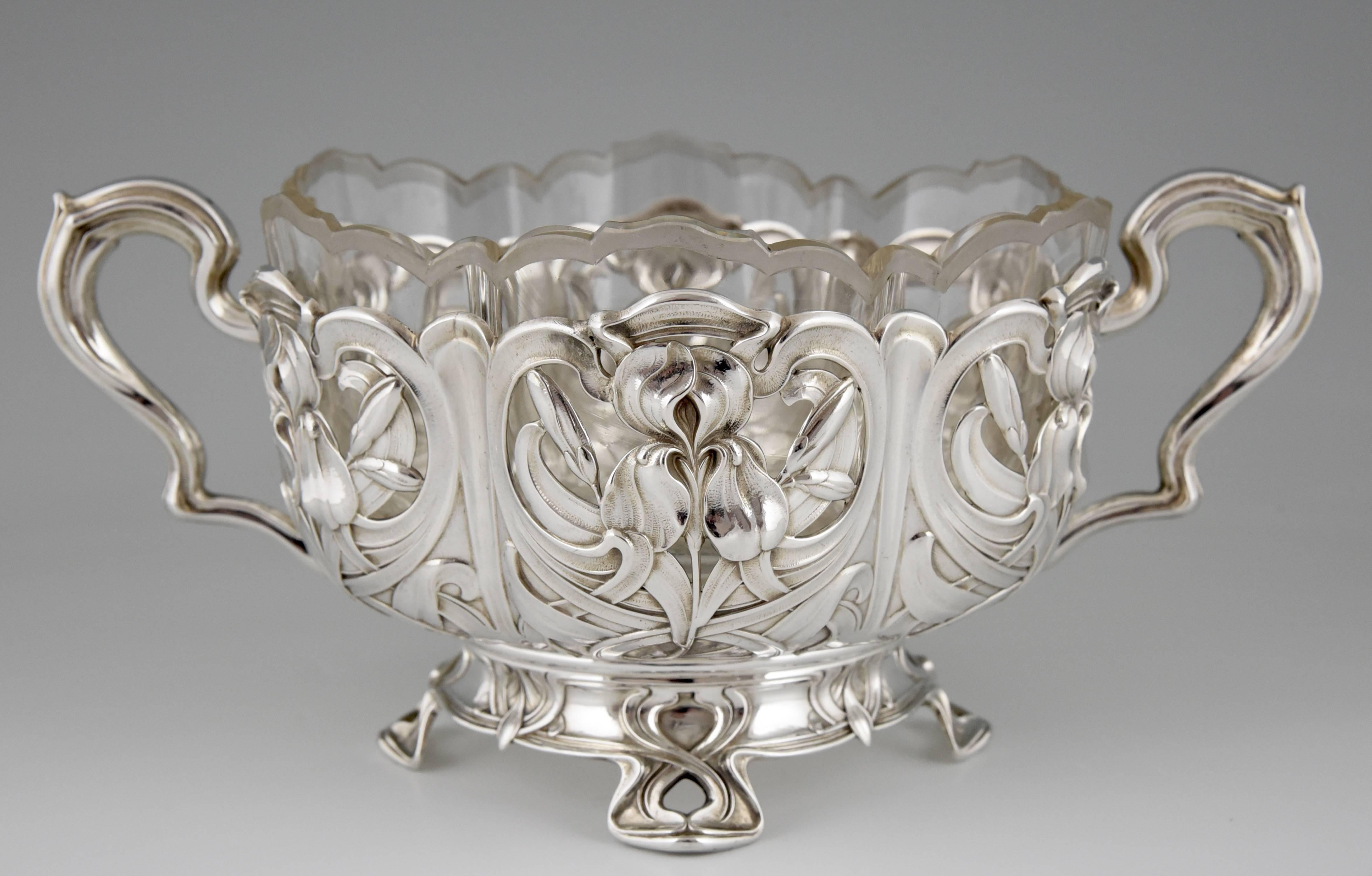 An Art Nouveau silver flower dish with glass liner. Floral design with irises. 
Silver, 800. 
Original glass liner with frosted glass rim.	

Literature:
 “Art nouveau and art deco silver“  Written by Annelies Krekels Aalberse,  Published by