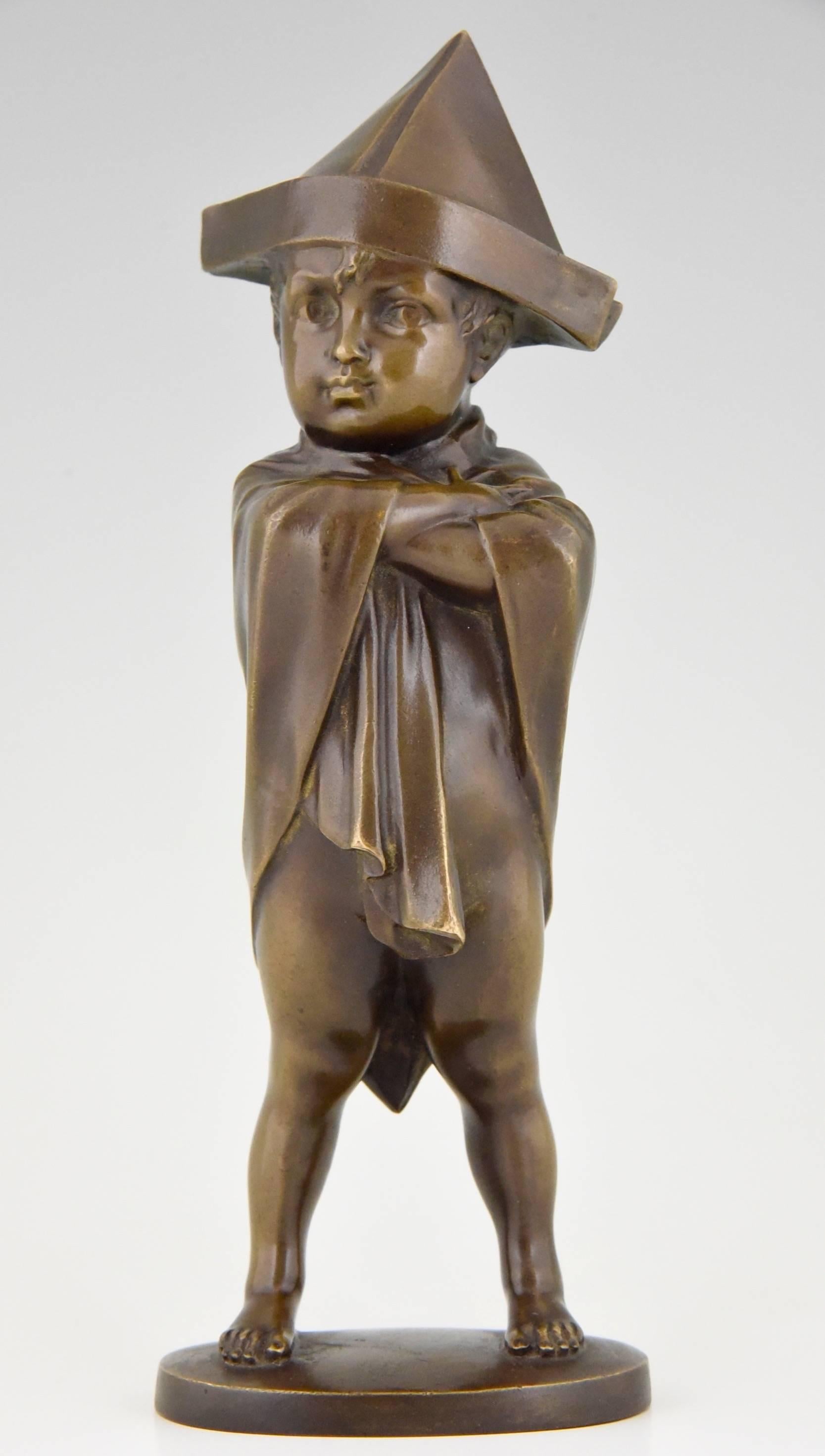 Little Napoleon.
 Boy with a cloth around his shoulders and a newspaper hat disguised as  Napoleon. 
By Joseph Lorenzl.
Signature/ Marks :  Lorenzl, stamped numbers. 	 
Style:  Art Deco.
Date: 1920.			
Material:  Bronze with brown