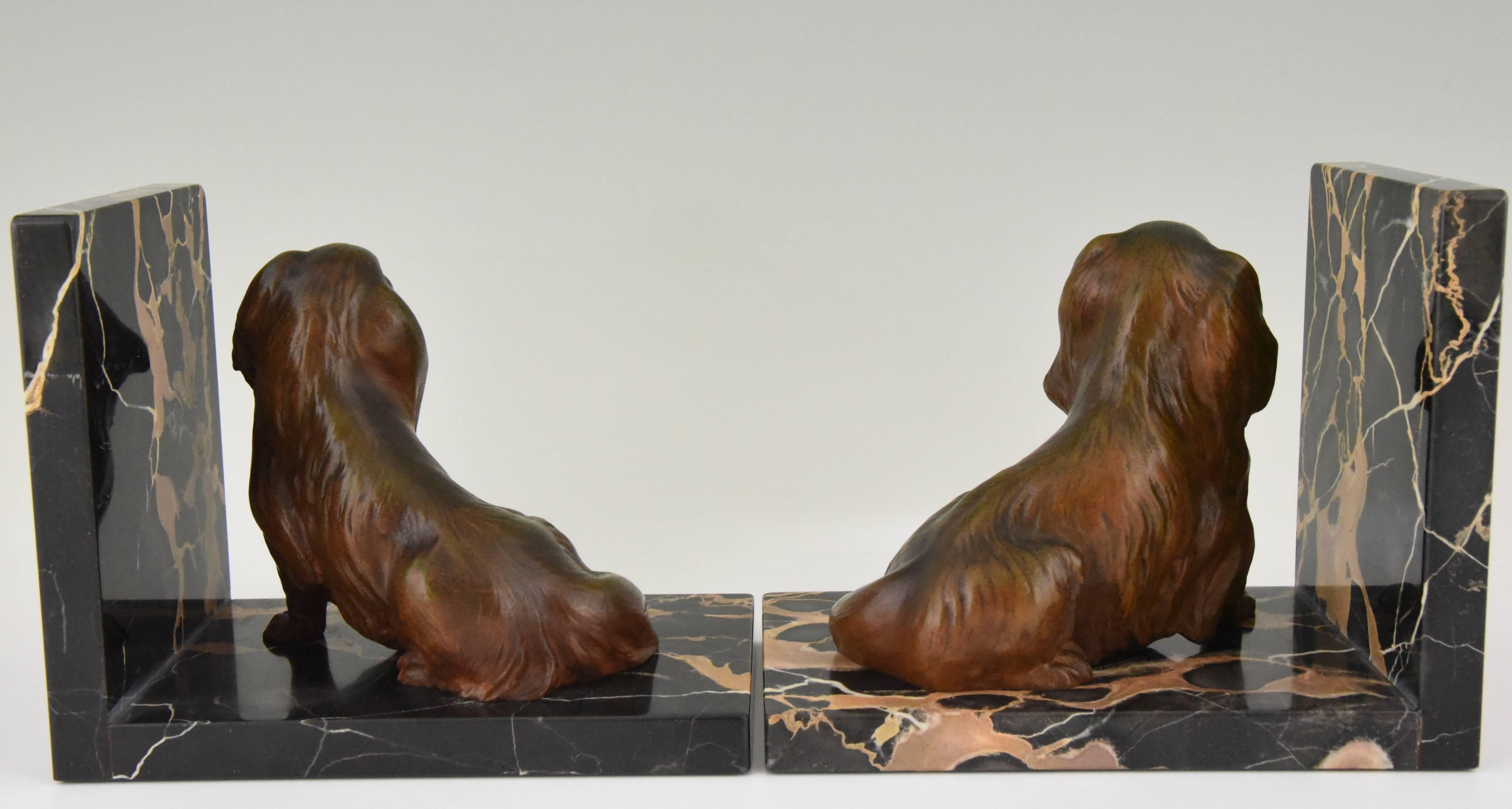 Lovely pair of Art Deco bronze Cavalier King Carles spaniel dog bookends by the French artist Louis Albert Carvin on Portor marble base. 

Artist/ maker: Louis Albert Carvin
Signature/ marks: L. Carvin
Style: Art Deco
Date: 1930
Material: