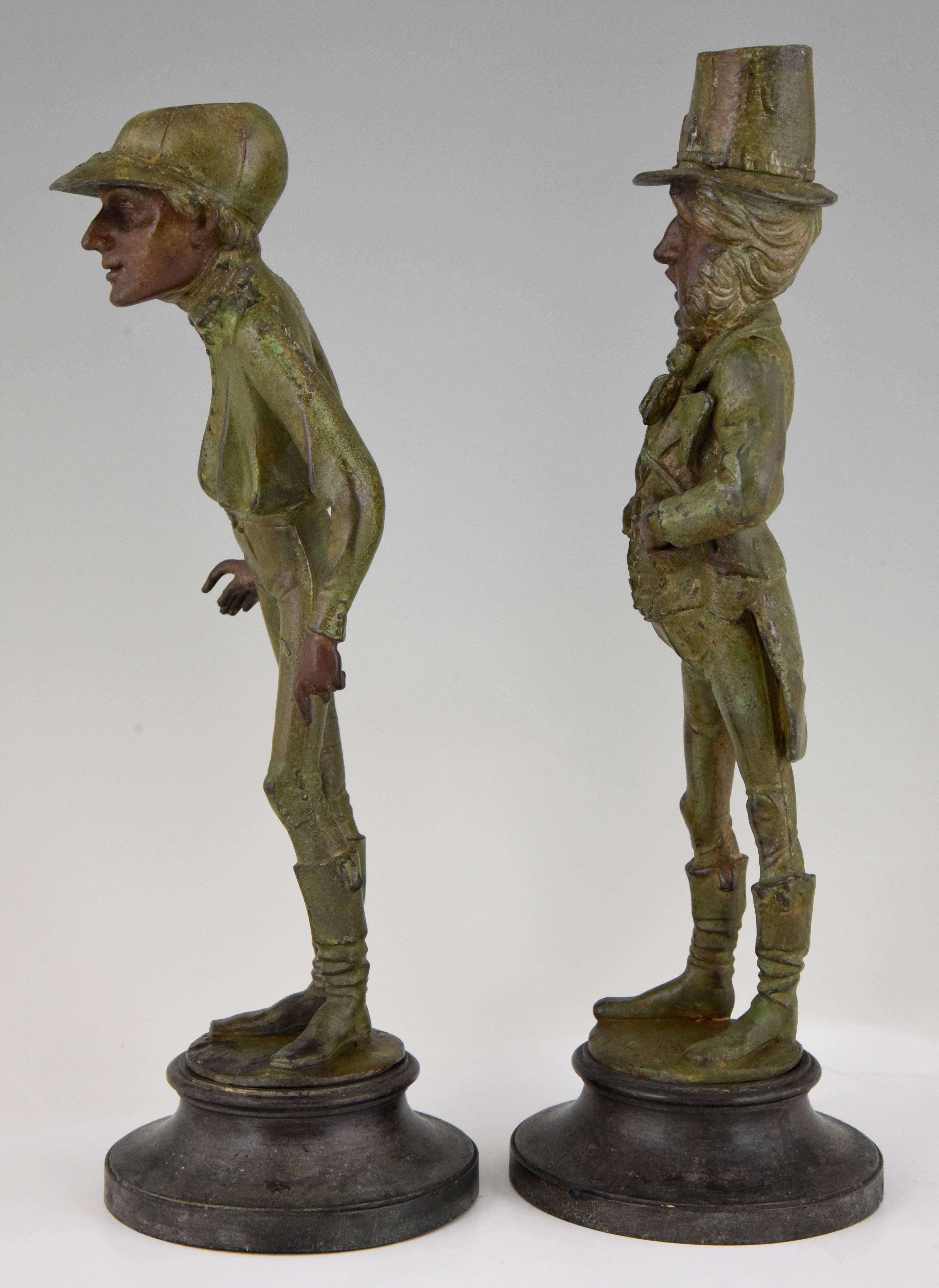 A pair of patinated metal figural candlesticks jockey and gentleman by Emila Guillemin.
Figures based on Vanity Fair print caricatures titled “The Favorite Jockey” and the “Statesman” after the cartoonist spy. 

Artist/ Maker: Emile