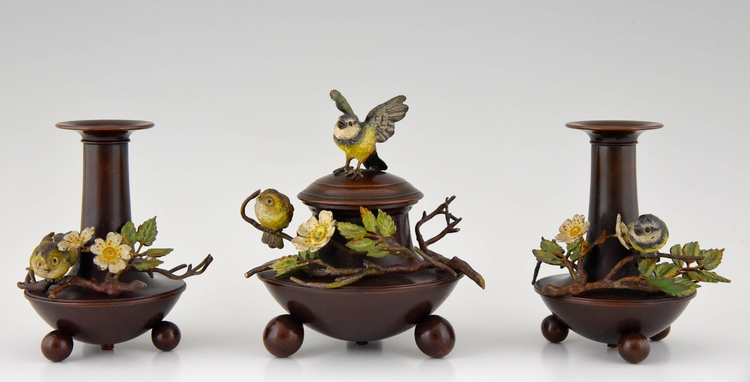 A Vienna bronze desk set, inkwell and two vases with birds.  
Very fine quality.  
Date:  Ca 1900	
		 
Material:  Cold painted bronze birds.  Bronze with brown patina.
Origin:  Austria. 			
Condition: Very good original condition.

Size