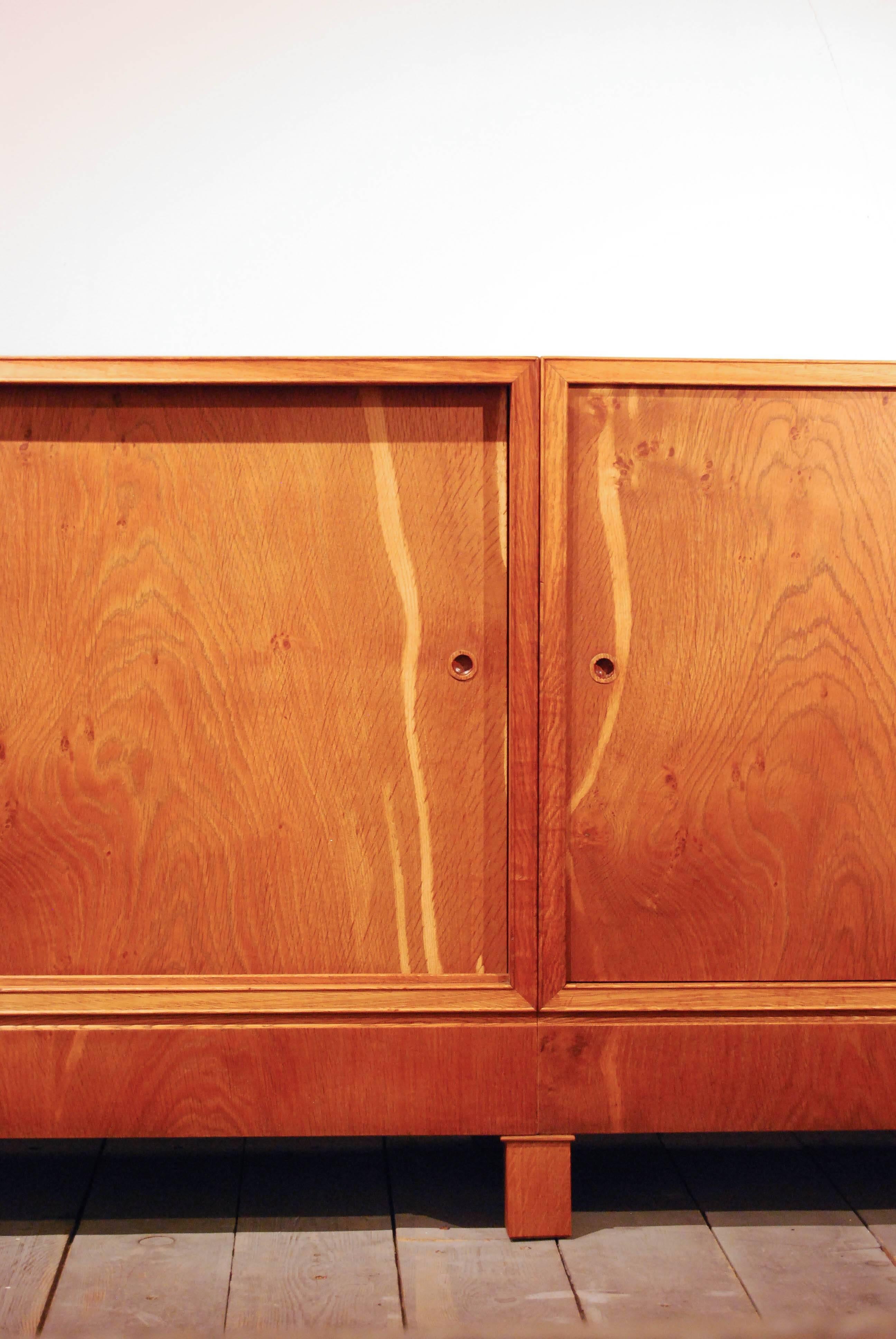 Frits Henningsen was a Danish furniture designer and cabinet maker who achieved high standards of quality with exclusively handmade pieces.

This enfilade includes four sliding doors made in oak.