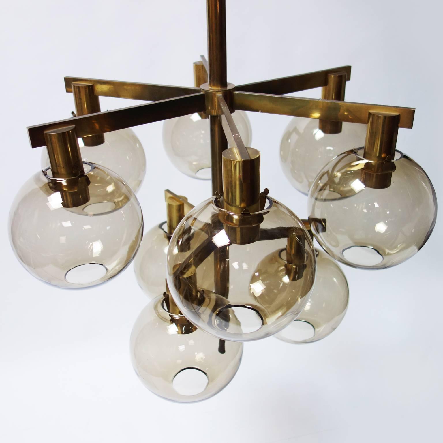 Fantastic large scale hanging fixture in brass with nine lights and smoked glass globes. 

Designed by Hans-Agne Jakobsson for Markaryd.

Original patina, could be polished to be really shiny, if requested.