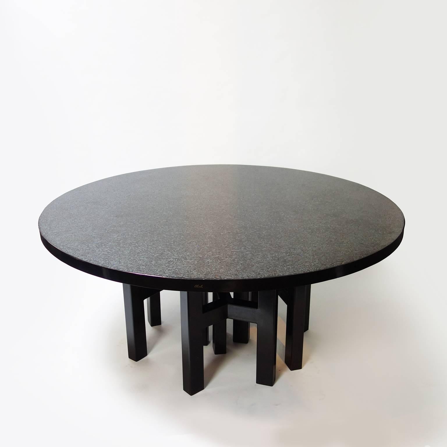 Dining room table by Ado Chale composed of a tabletop, in black resin with a mosaïc of hematite stone speckled with lapis lazuli stone and a set of four tripods legs in lacquered steel or polished aluminum.

Signed 