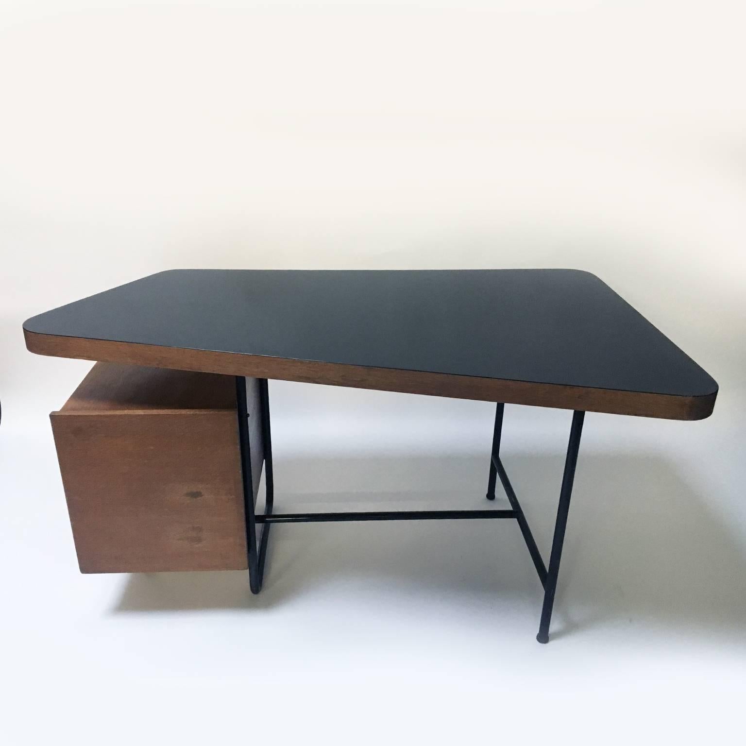 Adorable little writing desk in the style of Pierre Guariche.

Oak desk with black formica desktop, steel structure and a chest of drawers with brass details.