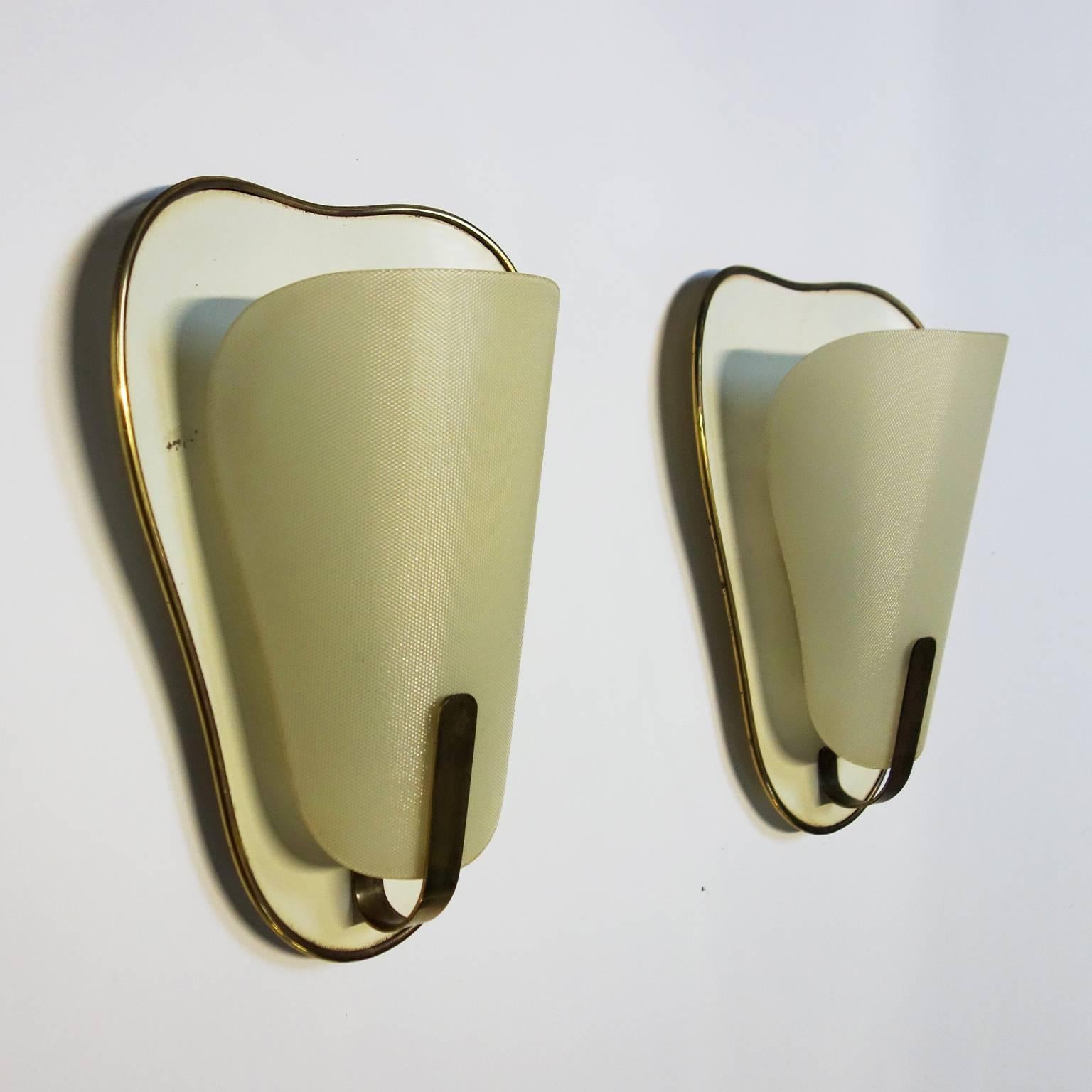 Pair of elegant French sconces with textured curved glass and brass details.

 