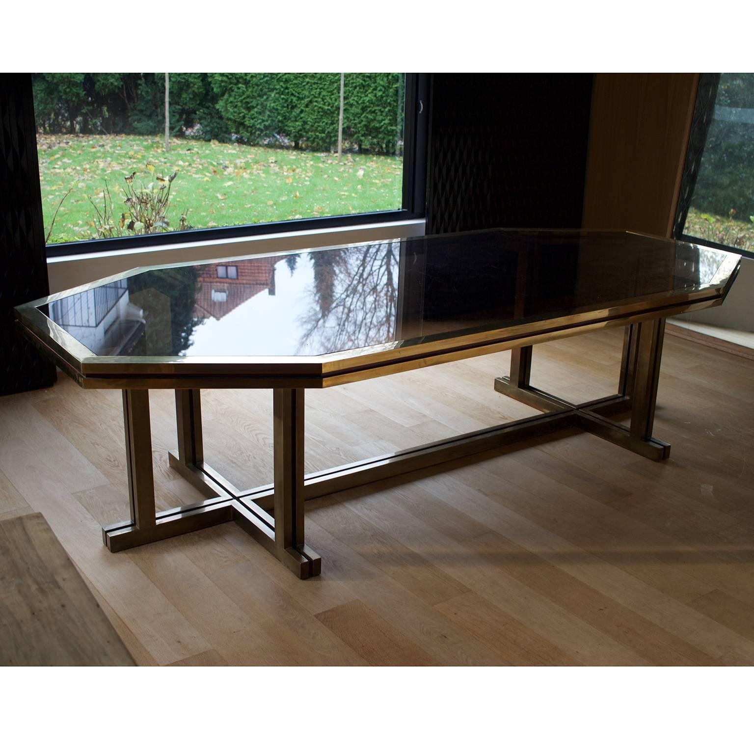 Brass and glass dining room table by Maison Jansen.

Brass structure with smoked glass tabletop.