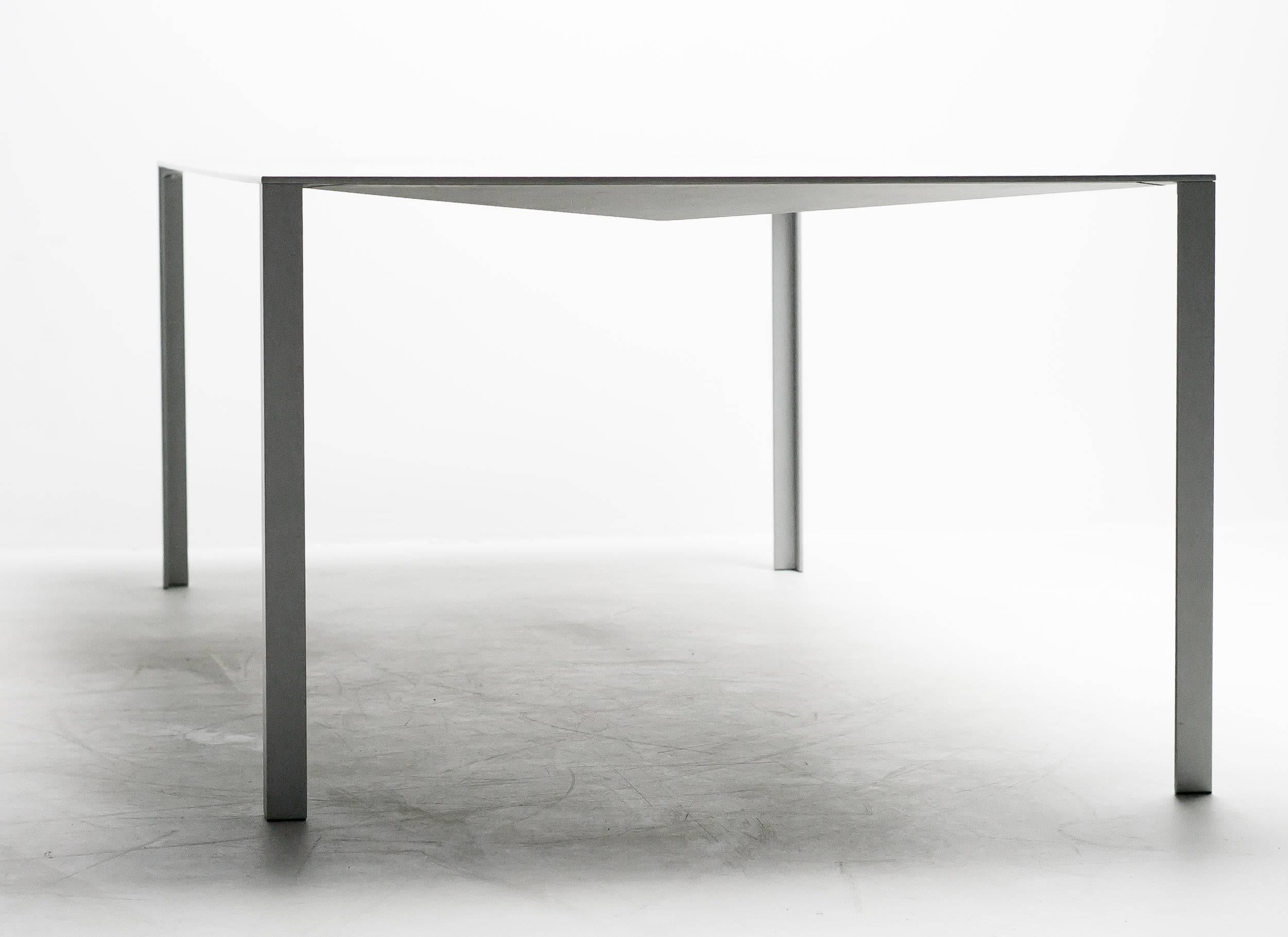 The early example of the Jean Nouvel less dining or writing table.
Manufactured by Unifor.

An aluminum table the strength of which lies in a play on corners and folds. 
Designed originally for the foundation Cartier in Paris.

Excellent fast