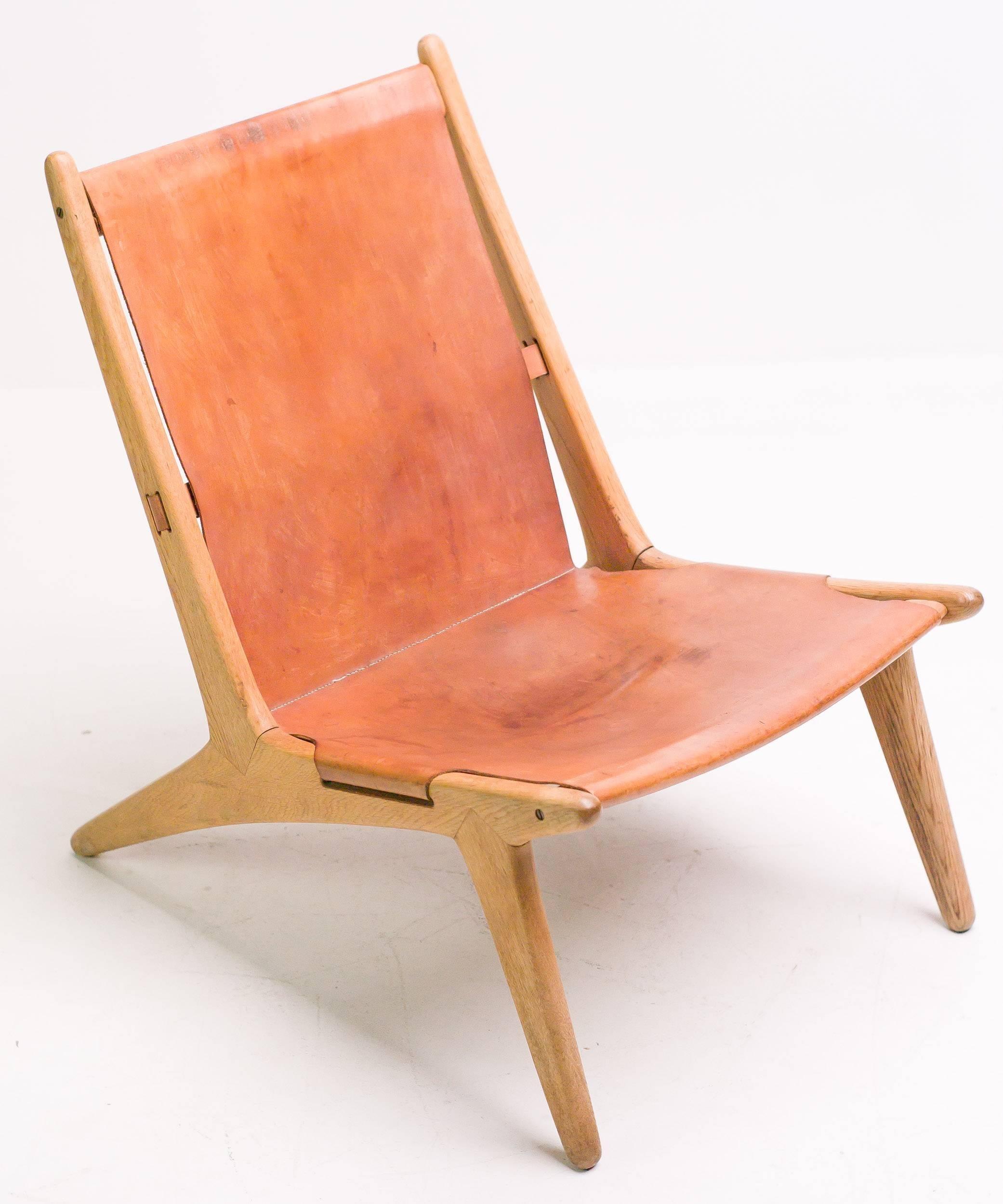 Hunting chairs designed by Uno & Osten Kristiansson for Vittsjömöbel, in beautifully aged original natural saddle leather and oak. Marked with label.

Excellent fast and affordable worldwide shipping.
White glove delivery available upon request.