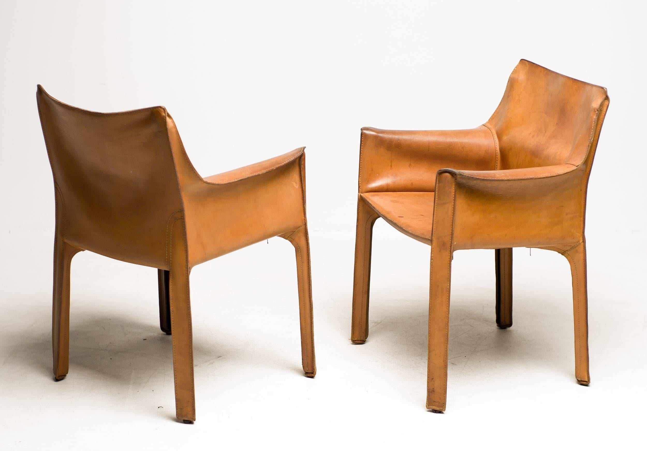 Cab chairs designed by Mario Bellini for Cassina Italy in the desirable and rare natural saddle leather. Great original vintage condition. Signed with molded manufacturer's mark and stamped in the leather.

Excellent fast and affordable worldwide