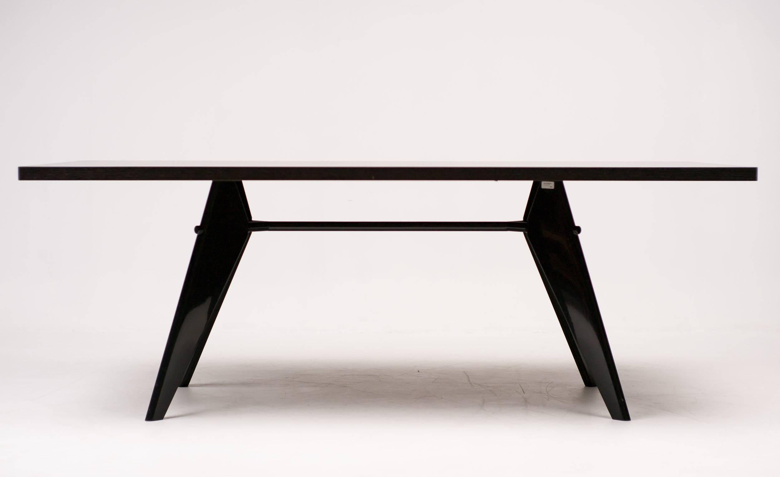 EM table, designed by Jean Prouvé, manufactured by Vitra.
Folded steel legs enameled in dark coffee, dark brown oak veneer top.
Marked with label.

Excellent fast and affordable worldwide shipping.
White glove delivery available upon request.