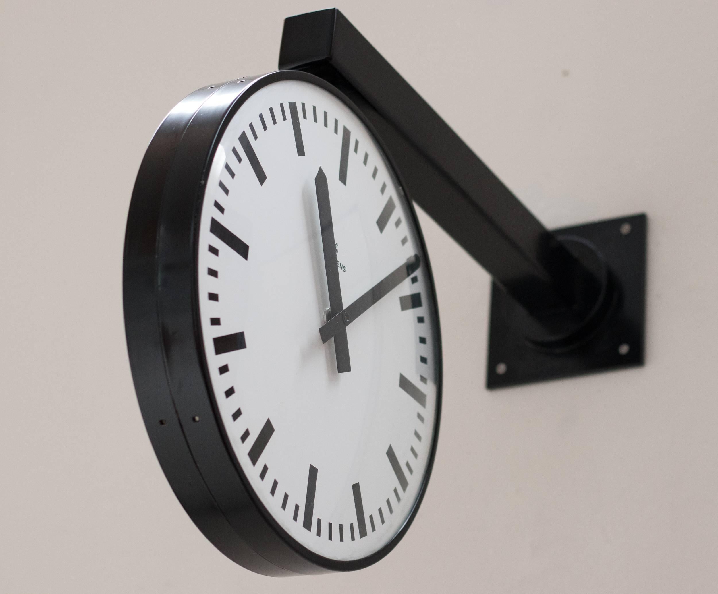 A Siemens double faced railway station clock from the late 1960s or early 1970s. These clocks have been a familiar sight on European railway stations and airports for decades. The clock can swivel on its base.
This is a low voltage clock that was