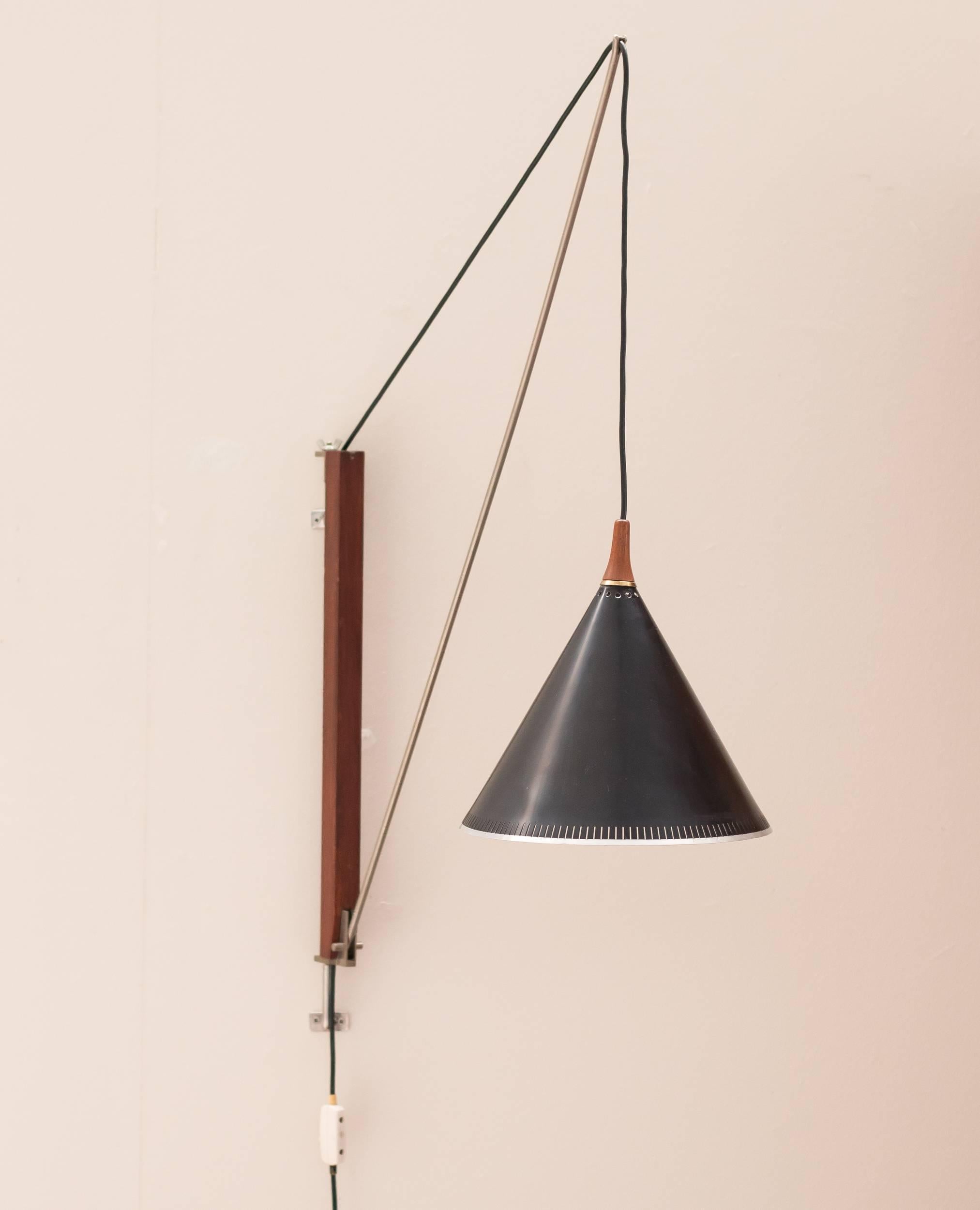 Beautiful arc wall lamp by Dutch designer Willem Hagoort.
Swiveling teak wall mount and adjustable nickel-plated steel arm.
The black enameled steel shade is height adjustable.

Excellent fast and affordable worldwide shipping.
White glove
