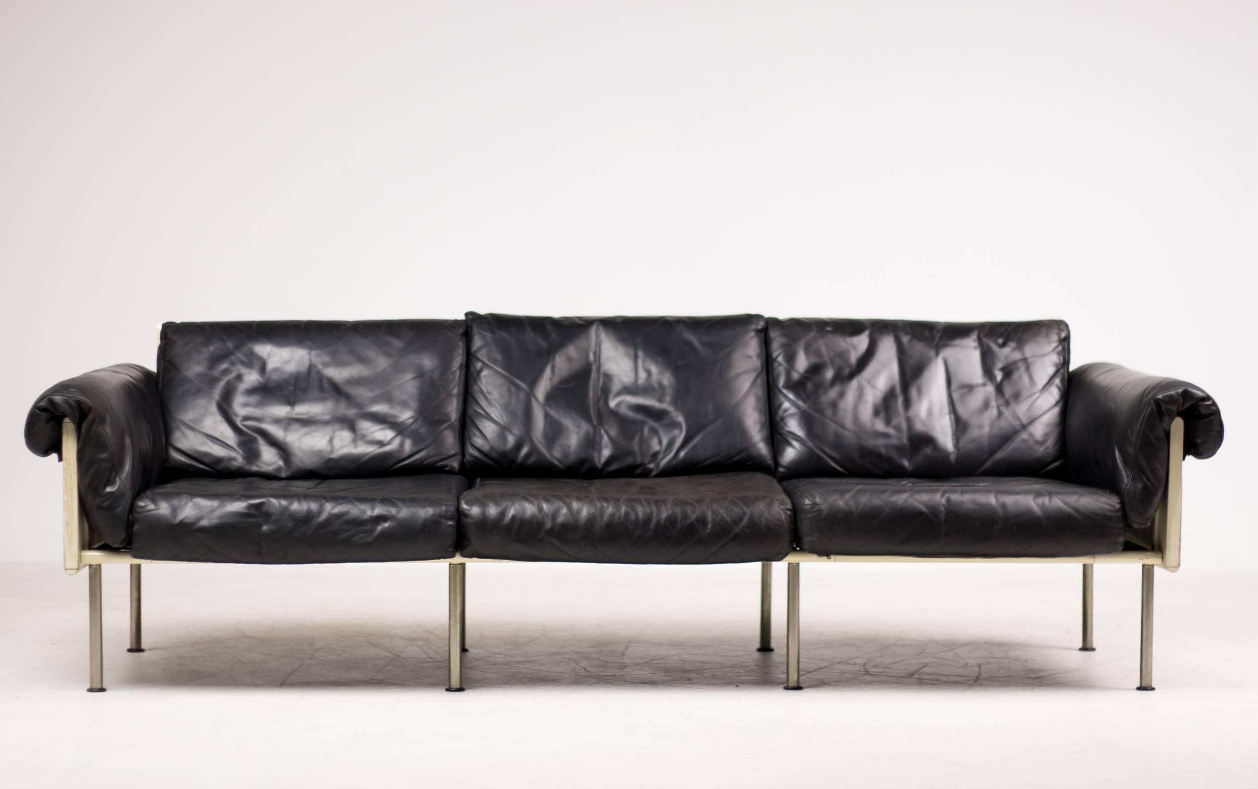 Architectural sofa in original black leather by Yrjö Kukkapuro for Haimi, Finland. 
White enameled tubular steel frame with painted plywood panels.
Marked with label.

Excellent fast and affordable worldwide shipping.
White glove delivery