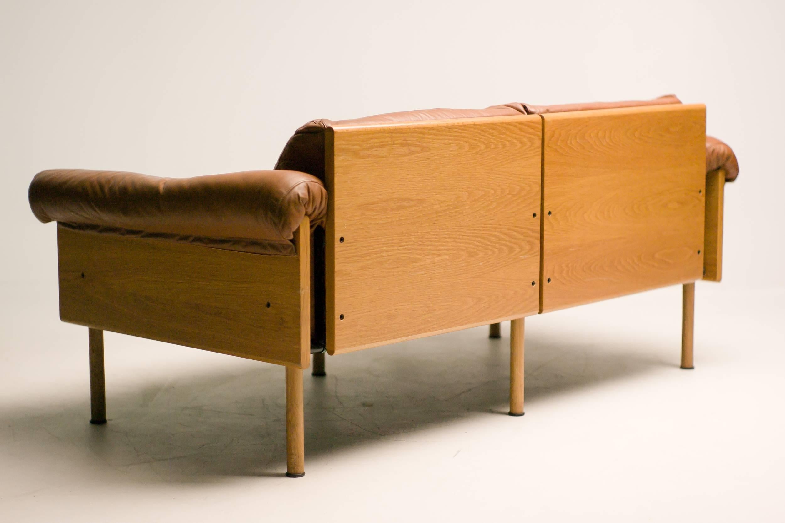 Original brown leather and oak Ateljee sofa by Yrjö Kukkapuro for Haimi, Finland. Marked with label.

Excellent fast & affordable worldwide shipping.
White glove delivery available upon request.
