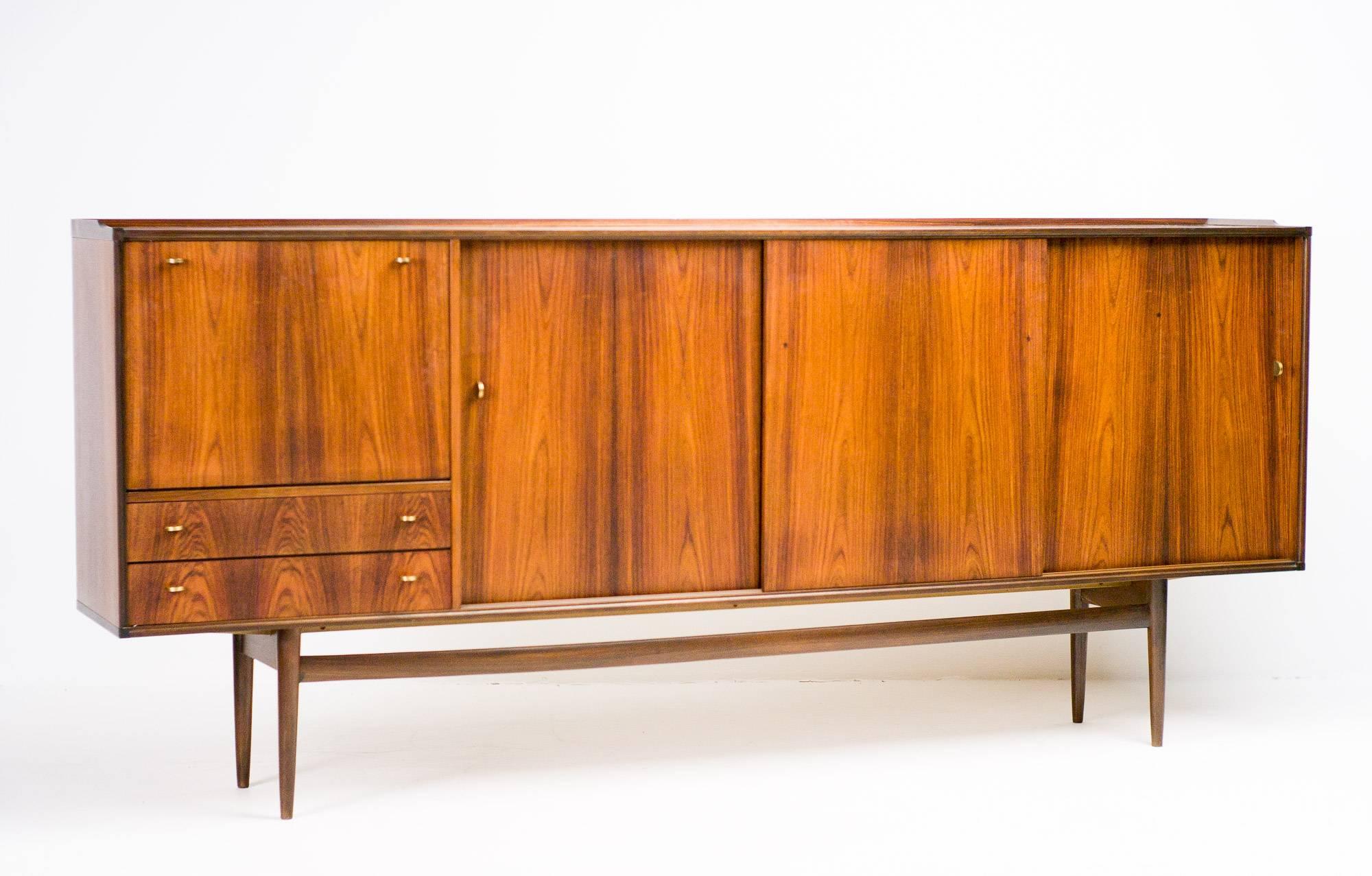 Excellent rosewood credenza made in 1960 by Fristho, Netherlands.
Exquisite details such as refined solid brass handles and Carrara marble shelves in the bar compartment. Rosewood outside, birch veneer inside.
Unrestored excellent original vintage