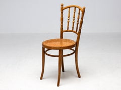 Paire de chaises en bois courbé et rotin signées Jacob & Josef Kohn, vers 1950
