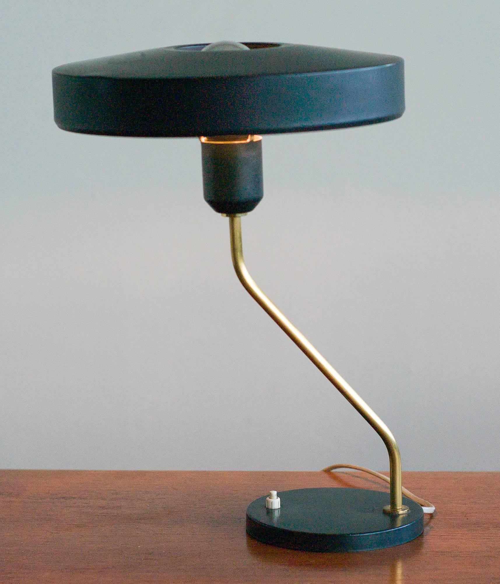 Dutch, bent brass stem, desk lamp designed by Louis Kalff for Philips. Dark forest green enamel steel. Marked with label.

       