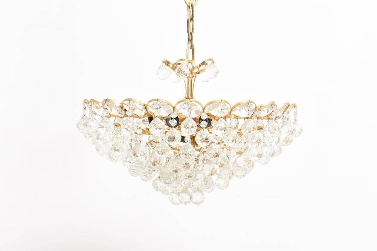 A beautiful gold-plated brass chandelier designed by Palwa with faceted crystal spheres, shine like diamonds.
Impressive in its size and volume of the crystal spheres.Nine bulbs.Dimensions:Width 60 cm/Height 80 cm.