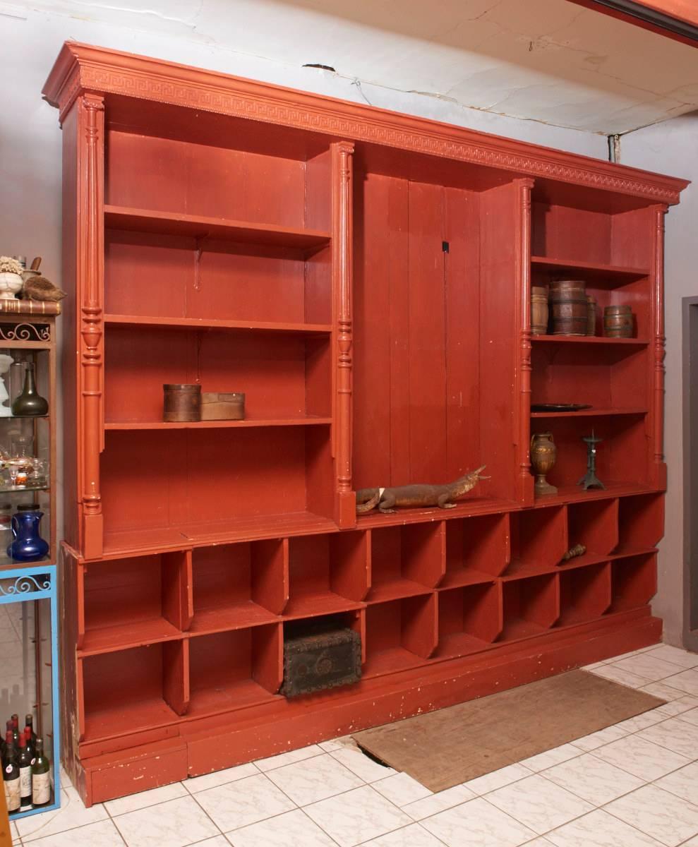 A Belgian mid-19th century, red painted store display cabinet.
A large and imposing antique Canadian pine display cabinet vitrine, woodcarving in abstract guirlande motif and four classical columns, full length shelves within the cabinet is finished