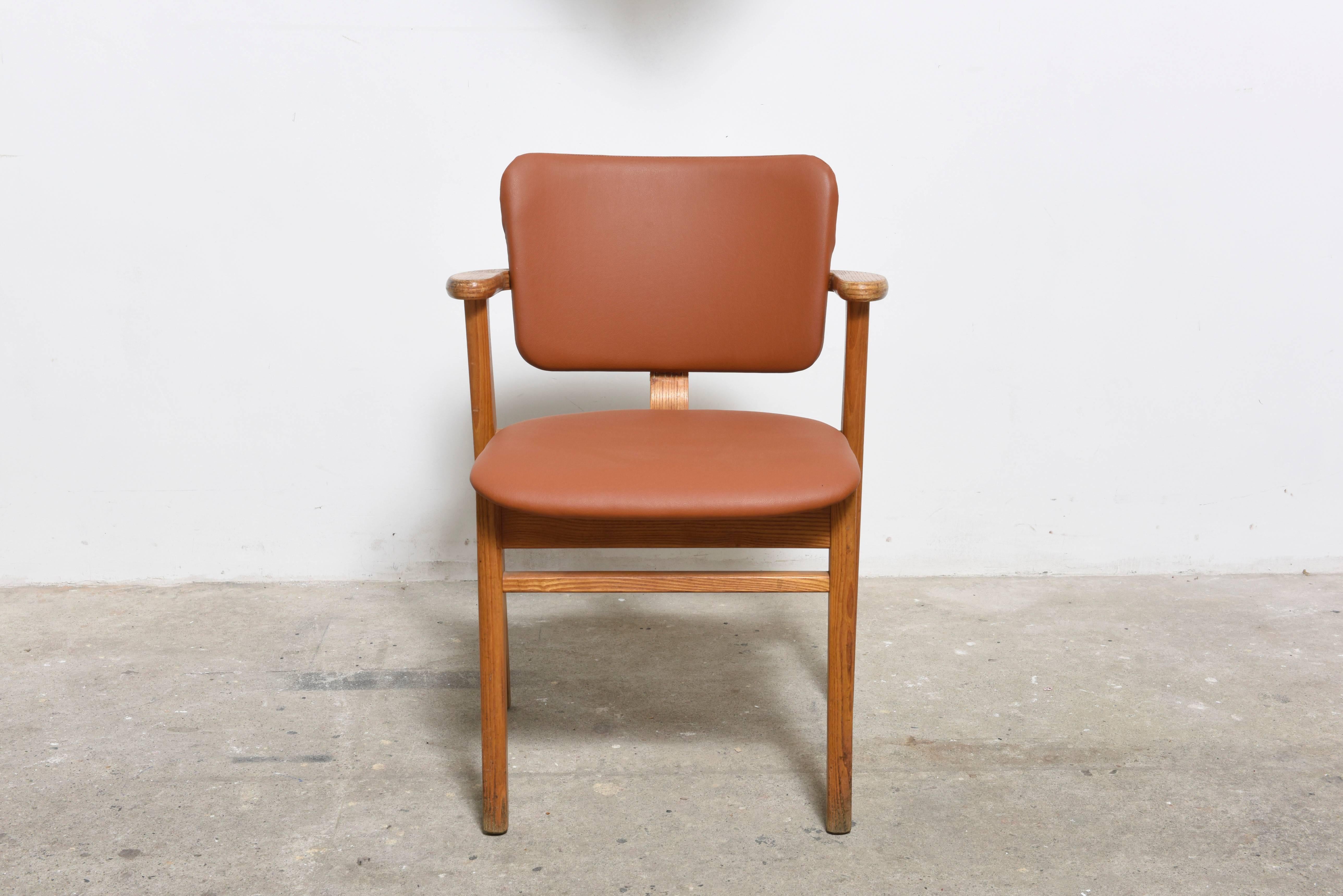 Set of three wooden chairs designed by Ilmari Tapiovaara, produced in 1953 by Keravan Puuteollisuus of Finland for U.S. distribution by Knoll. 

The seat is re-upholstered in camel leather, frame and armrests of solid birch.