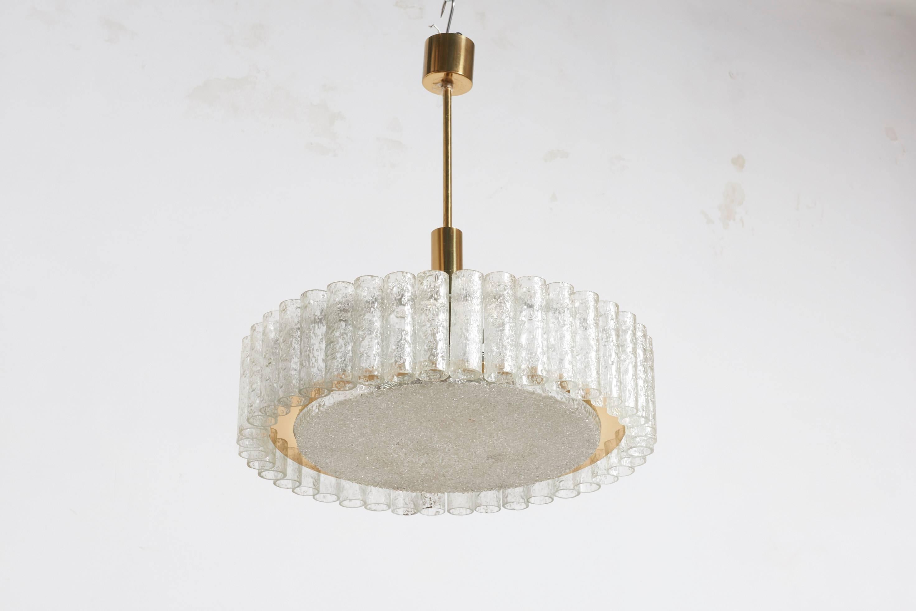 Large ice textured glass chandelier, one ring of glass cylinders suspended from a brass ring and textured disc, by Doria, Germany 1960s.