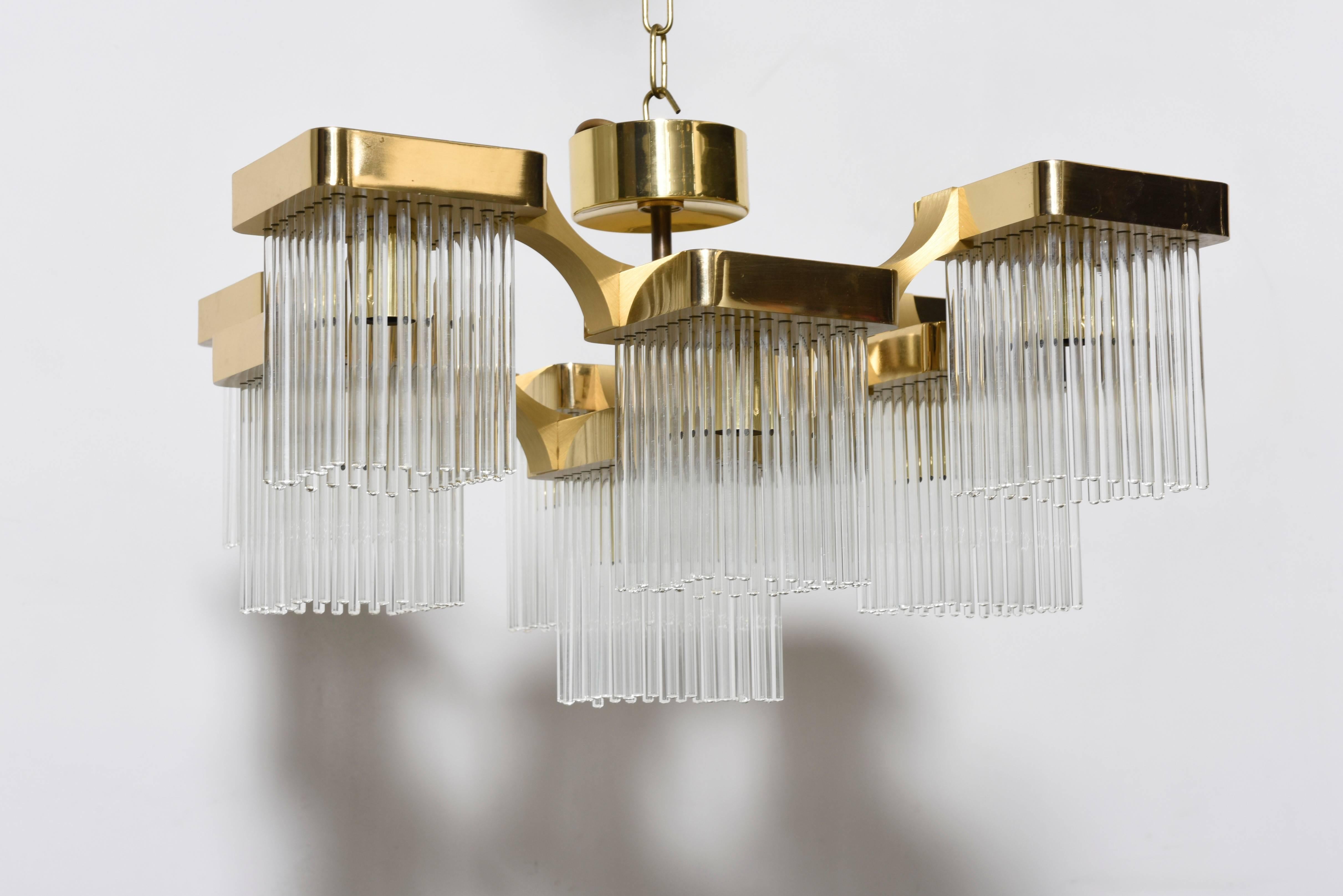 Labeled brass chandelier designed by Gaetano Sciolari, Italy, 1970s
Chandelier has nine arms brass frame that feature hanging glass rods. 

Sciolary design that mixes the chandelier well with all periods. 
Also available three sets of sconces in