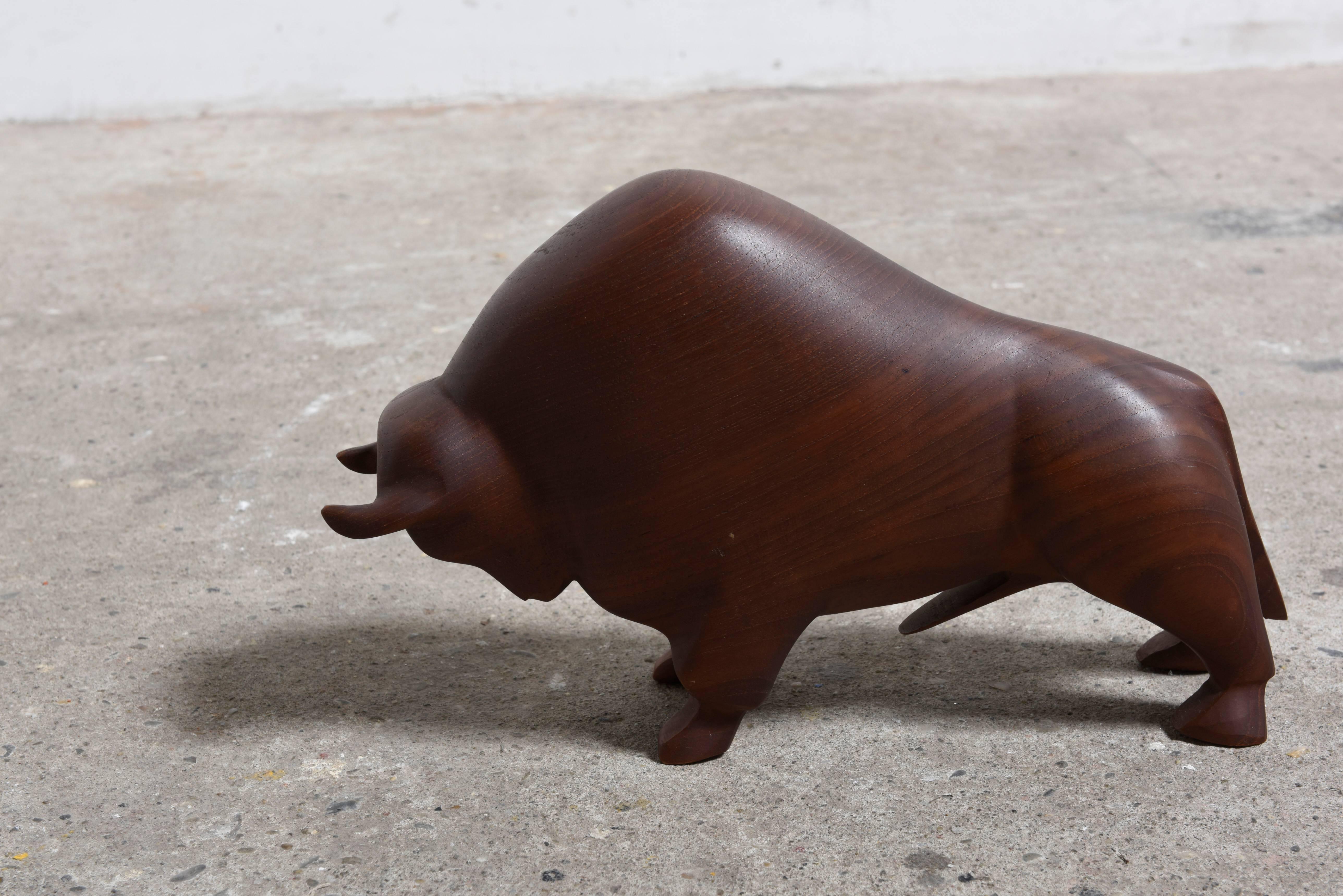 Mid-Century Modern teak bull sculpture, Denmark, 1960s.

Absolutely stunning piece of Danish Modern design. 
An abstract carved solid teak bull sculpture in great vintage condition. 
The shape of the bull works beautifully with the wood's grain.