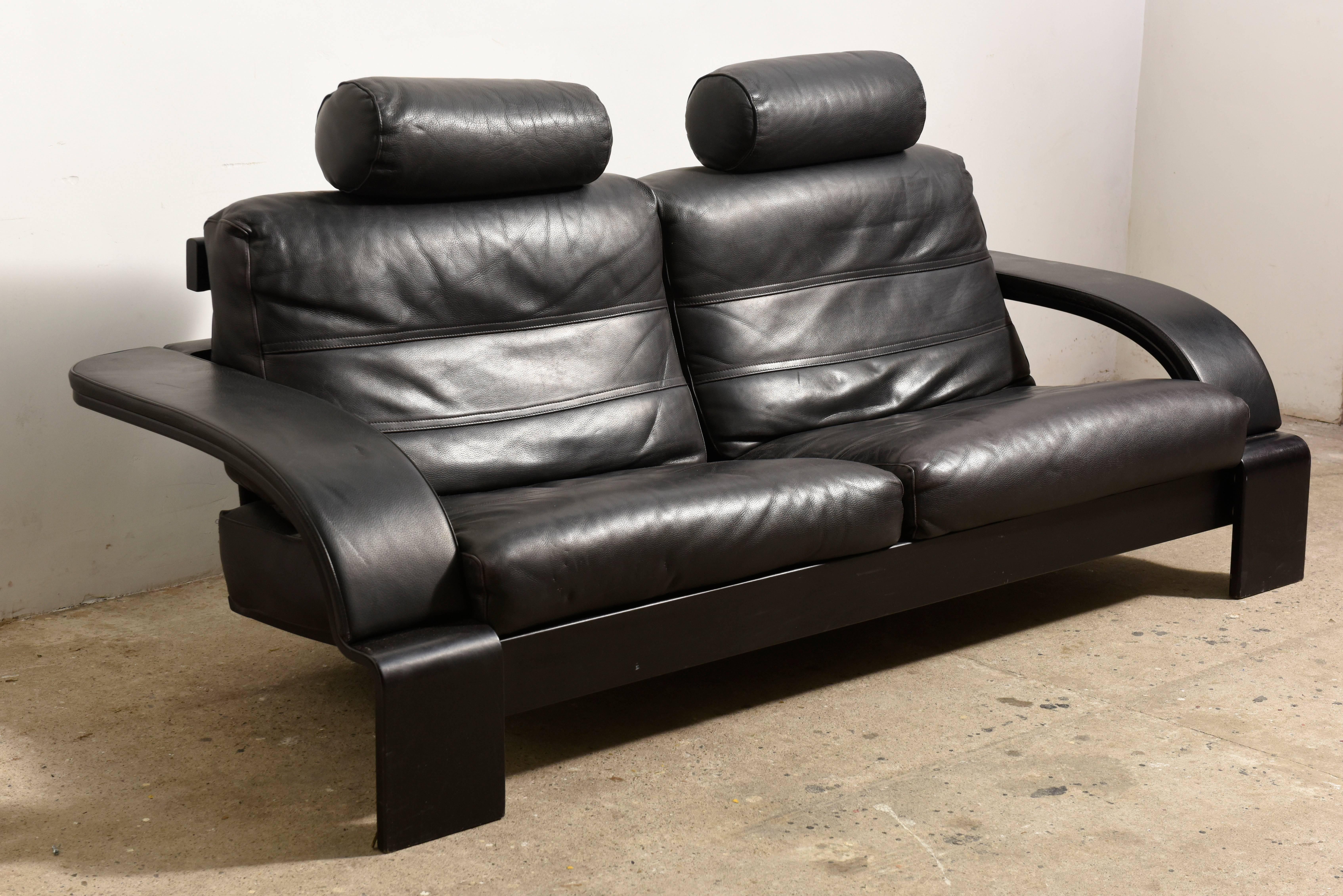Superb Italian made vintage black leather sofa 1980s In a minimalistic and modern design, with convenient functions, made for pure comfort and flexibility.The design of the chair, the back and the armrest create an original detail in line design,