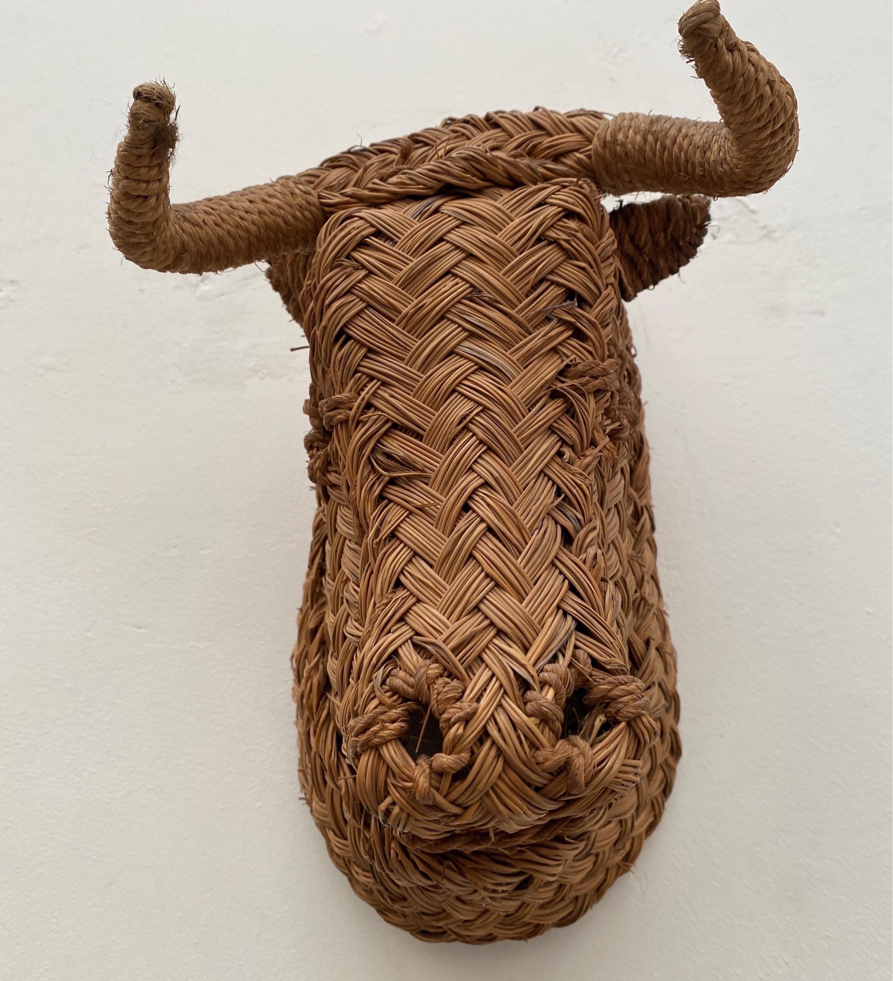 Very rare minotaur bull head with in wicker rattan wall decoration of the 60s. Origin of the south of france.In style of Audoux-Minet Height 34cm. Width 28cm. Depth 22cm. In excellent state minus signs of use. The wall mounted bull in rattan has a