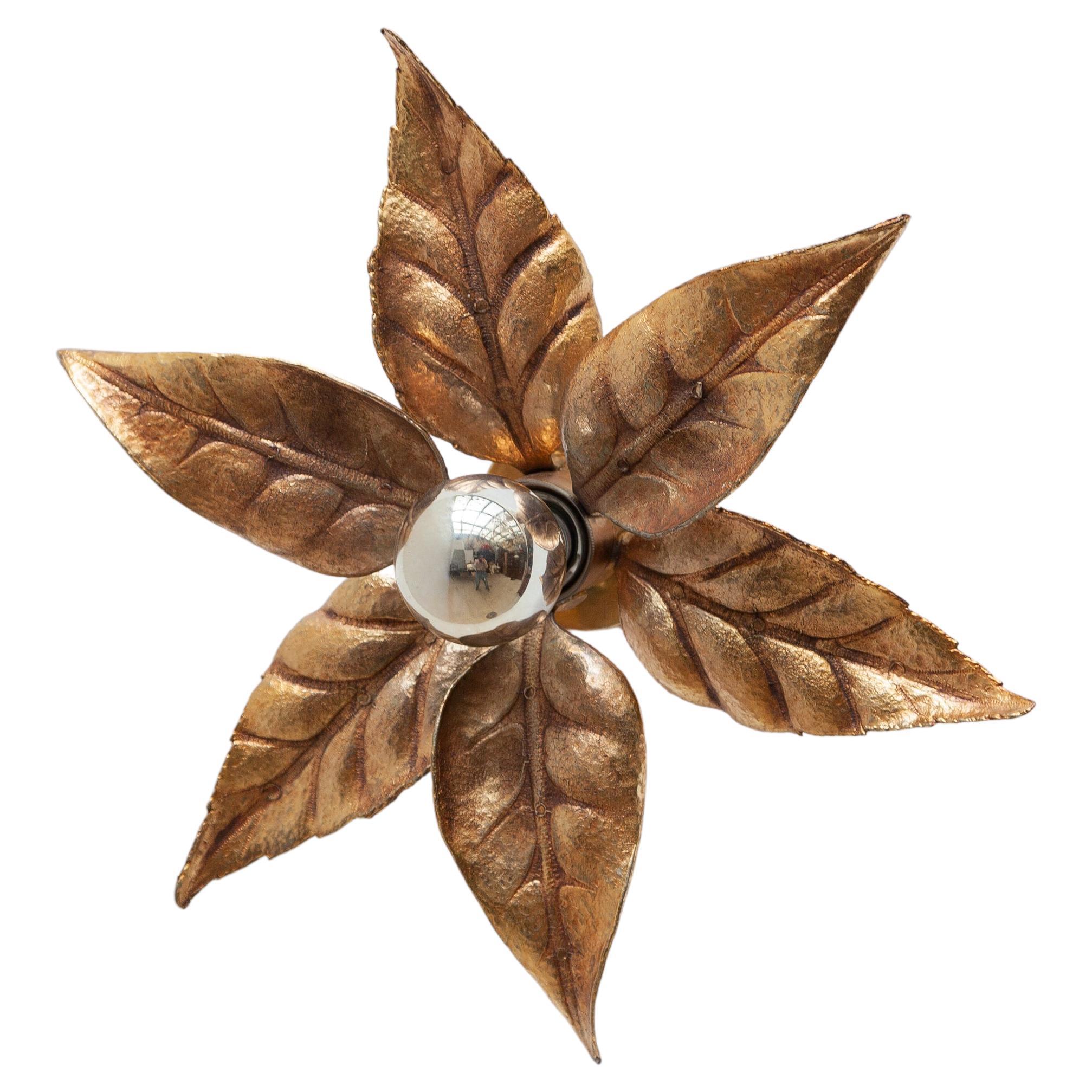 Beautiful flower shaped sconce by Willy Daro and manufacturer by Massive, Belgium 1970. These sculptural Hollywood Regency style lamp are made of gilt brass and have six textured leaves on a bar and circular base of the same finish. The golden brass