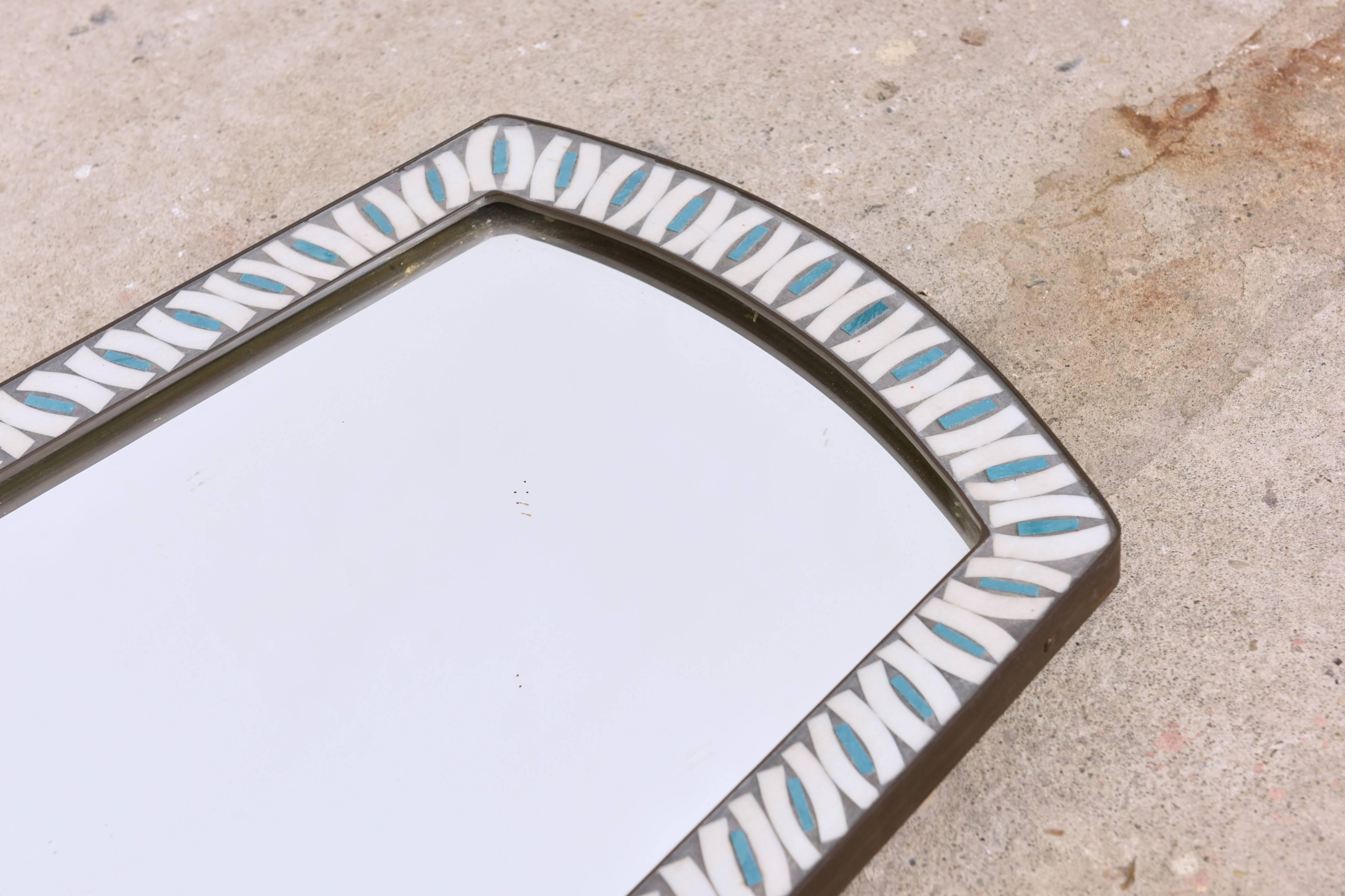 Beautiful large mosaic mirror from the 1960s. 
The mirror has blue and white color glass mosaic in a brass frame.