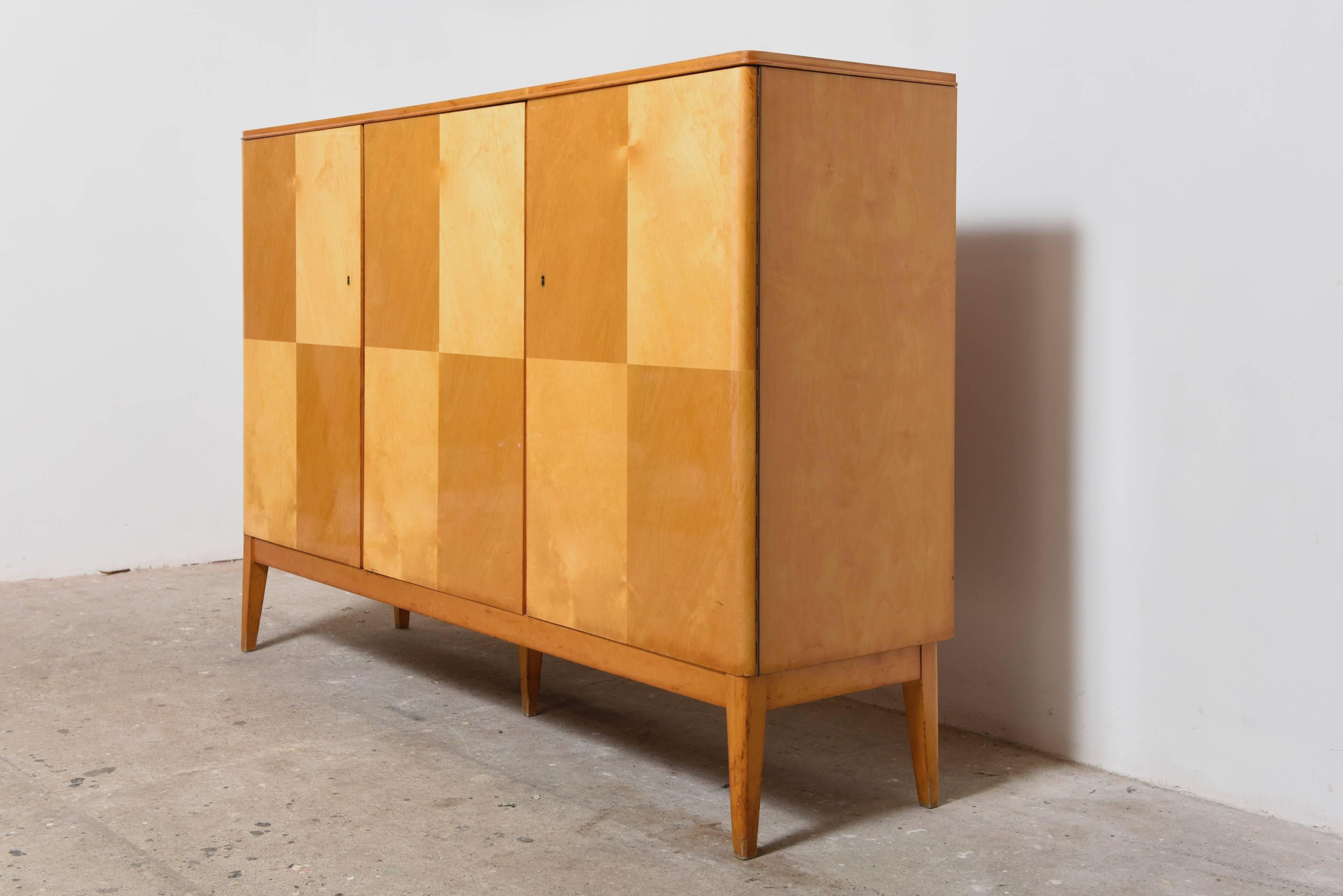 Beautiful 1950s sideboard, an example of Belgium craftsmanship in Satinwood also the functions quite beautifully in providing copious organized storage.
Original good condition.