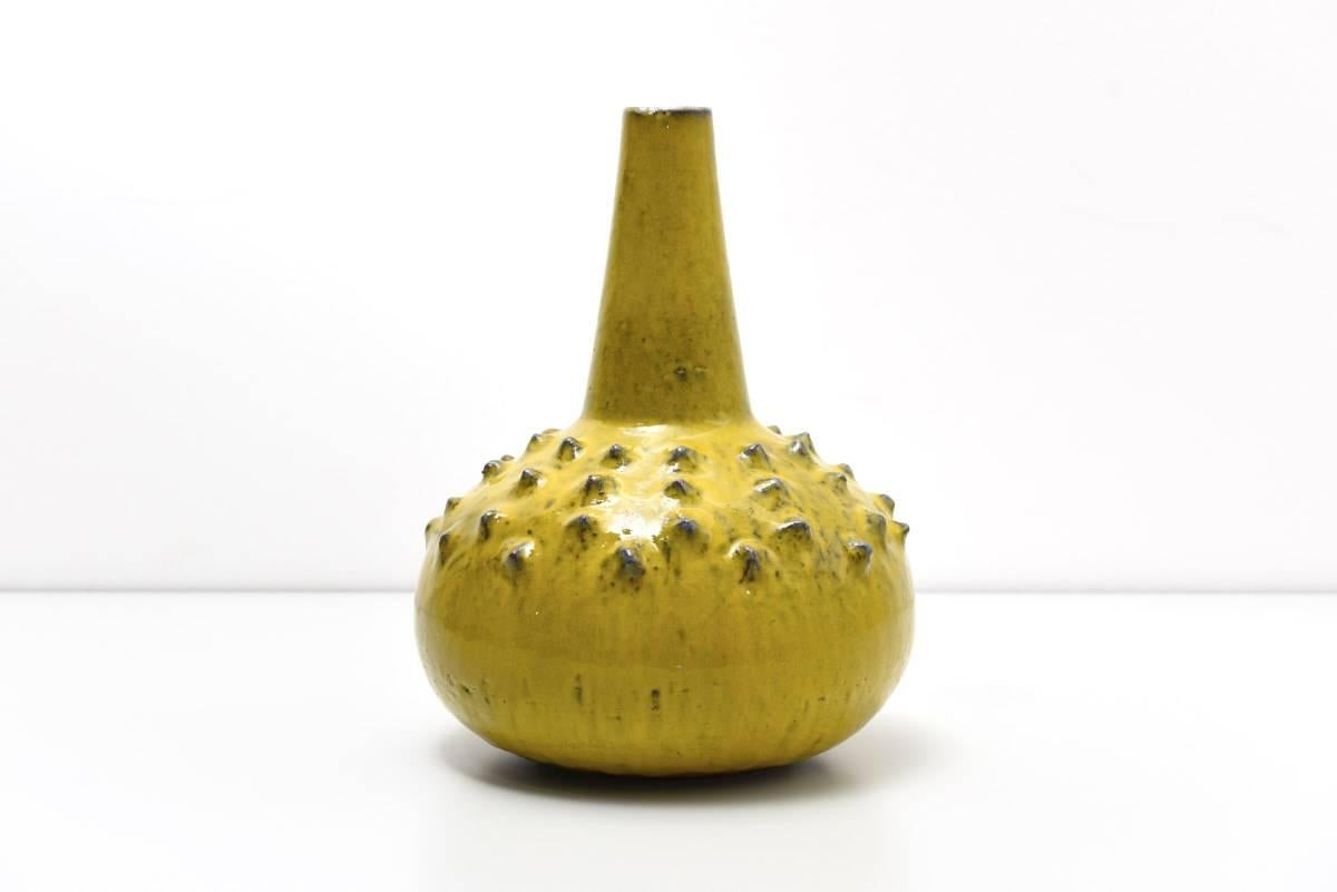 Yellow vase, Manufactured by Perignem is quite rare, as only a few items have been made in this colour.

Authenticated and signed with engraving pen by Perignem. This beautiful shaped vase in green-yellow and different shades of light grey is a nice