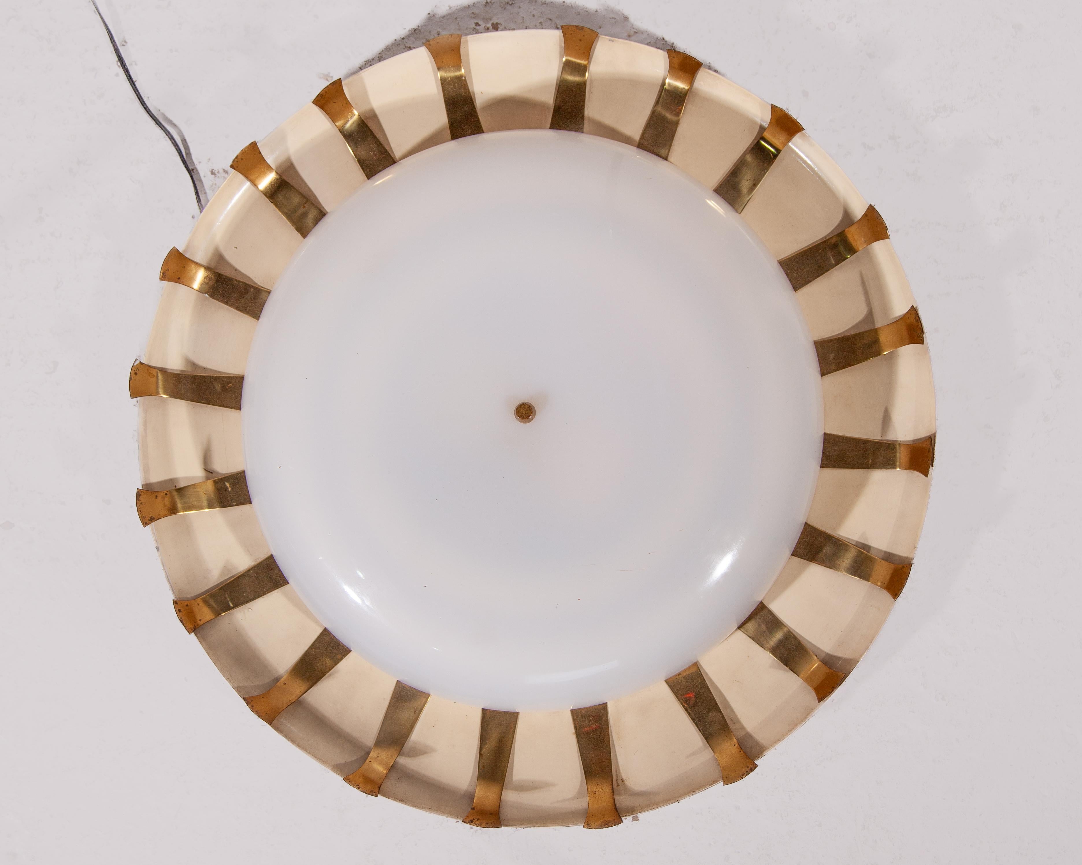 Beautiful fifties sunburst ceiling light with brass accents also to use as a wall lamp. We can offer a set of two ceiling lights, price per piece. Both Lights in a good original Vintage condition.