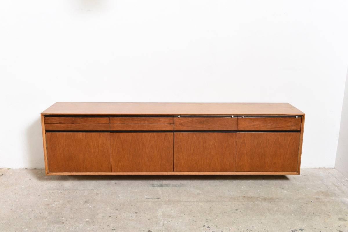 Designed by Fred Sandra a very rare large wall-mounted sideboard in rosewood and walnut, model Madison manufactured by De Coene, Belgium,1958.

This large sideboard is equipped with four drawers and two counters finished with an accent of black